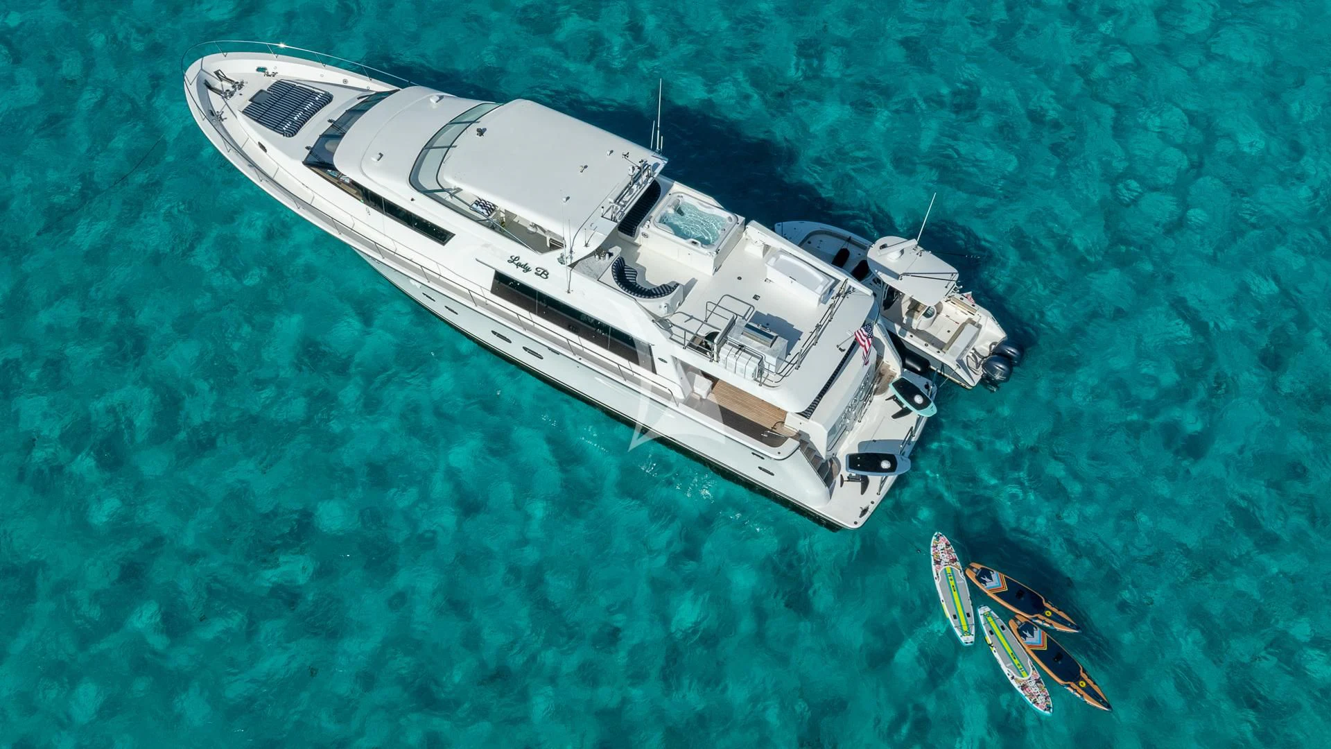a helicopter flying over a body of water aboard LADY B Yacht for Charter