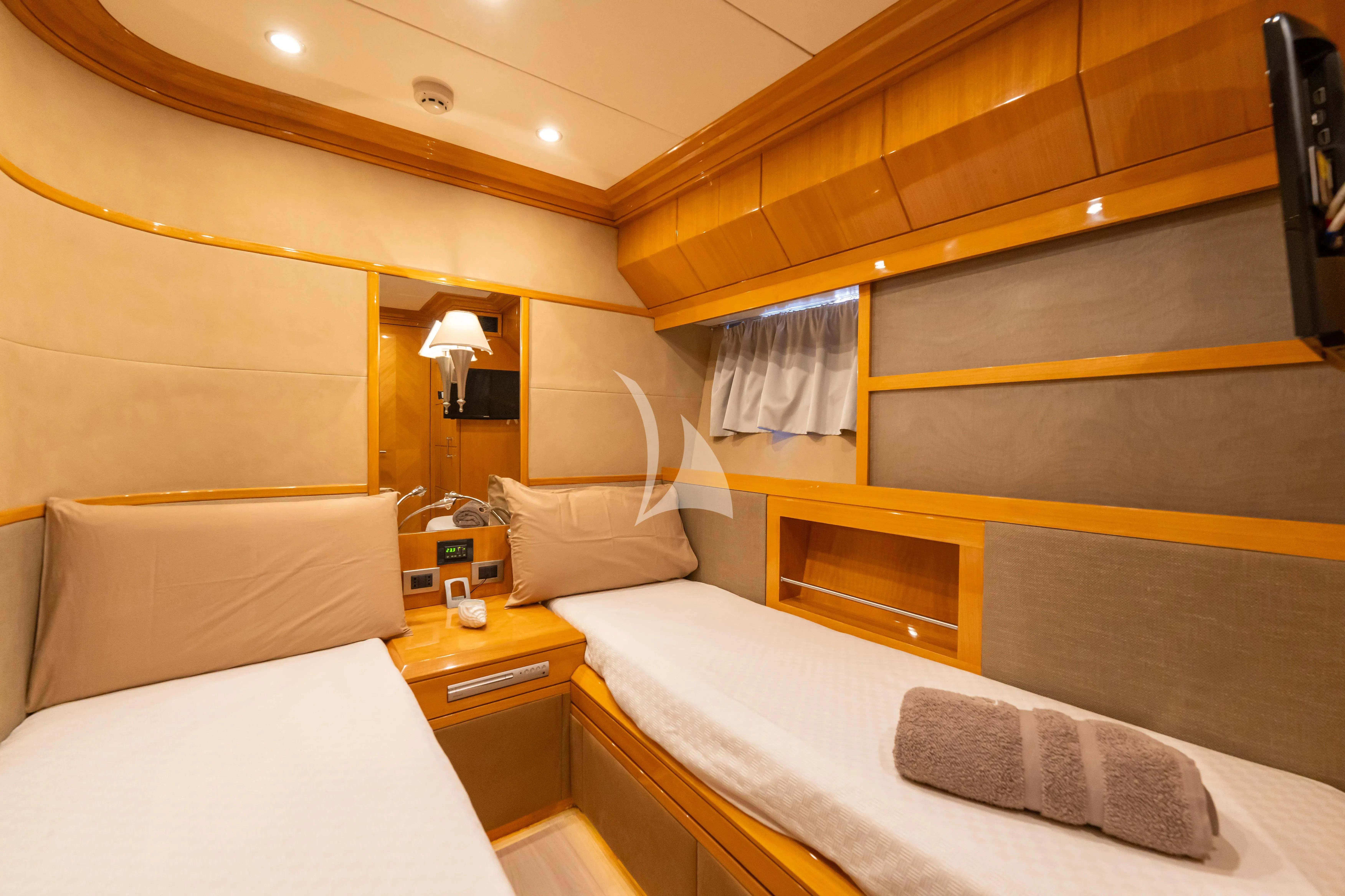 a room with a bed and a desk aboard LADY B Yacht for Charter
