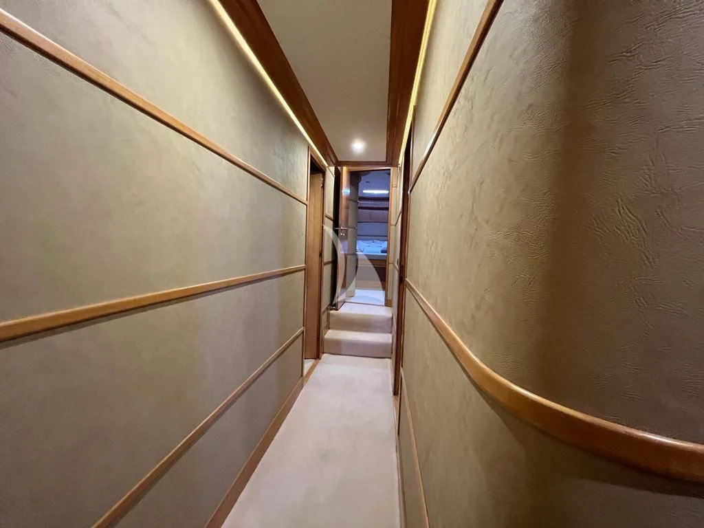 a long hallway with a person standing on the stairs aboard LADY B Yacht for Charter