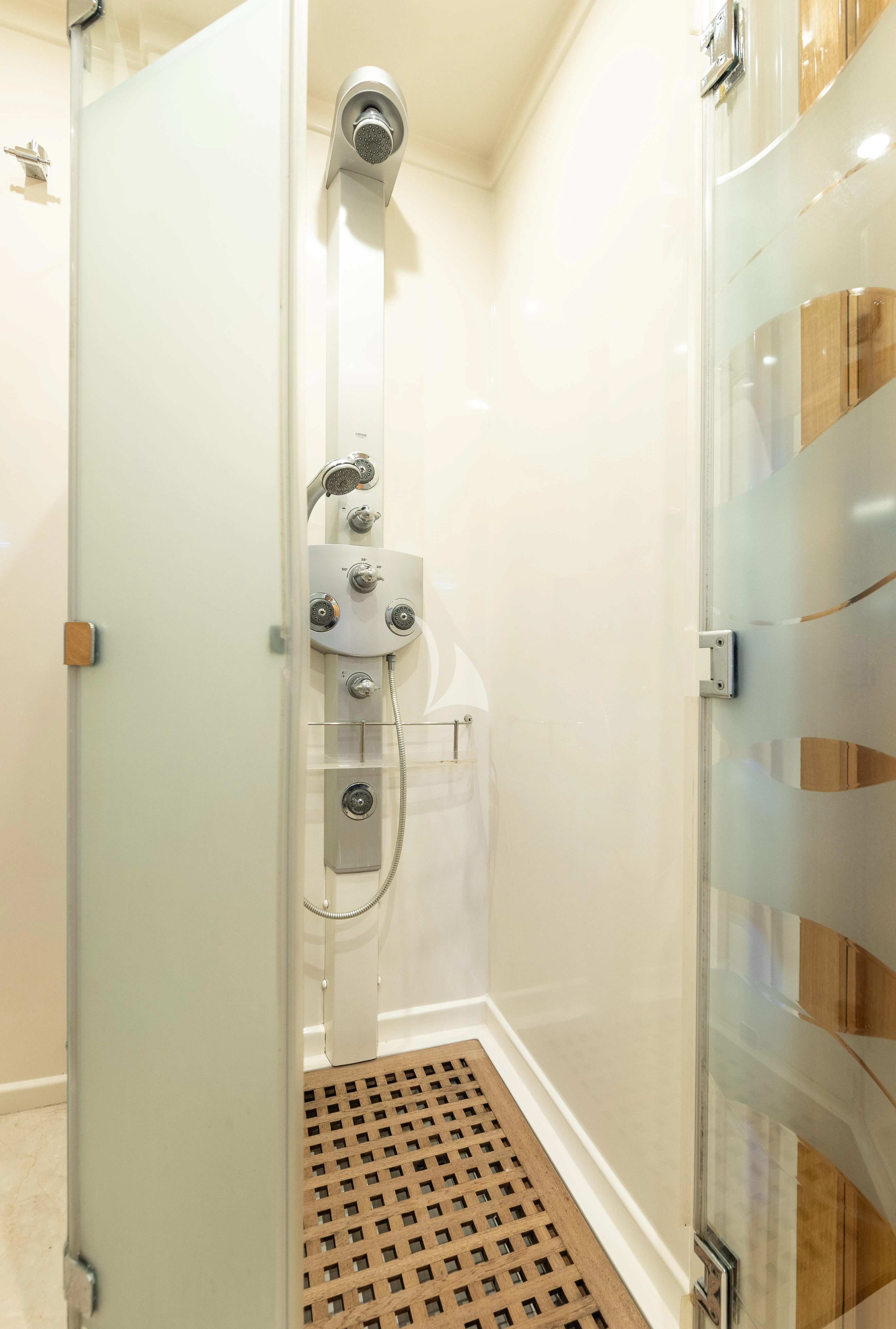a shower with a tile floor aboard LADY B Yacht for Charter