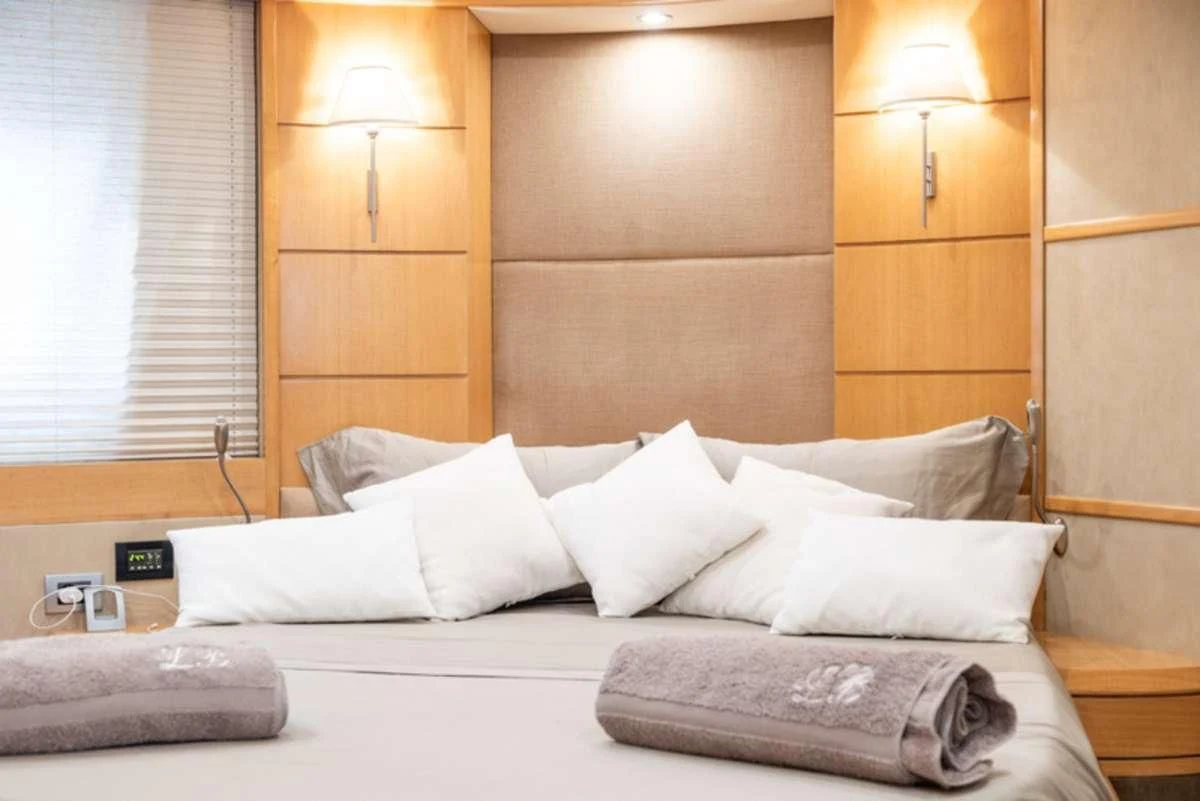 a bed with white pillows aboard LADY B Yacht for Charter