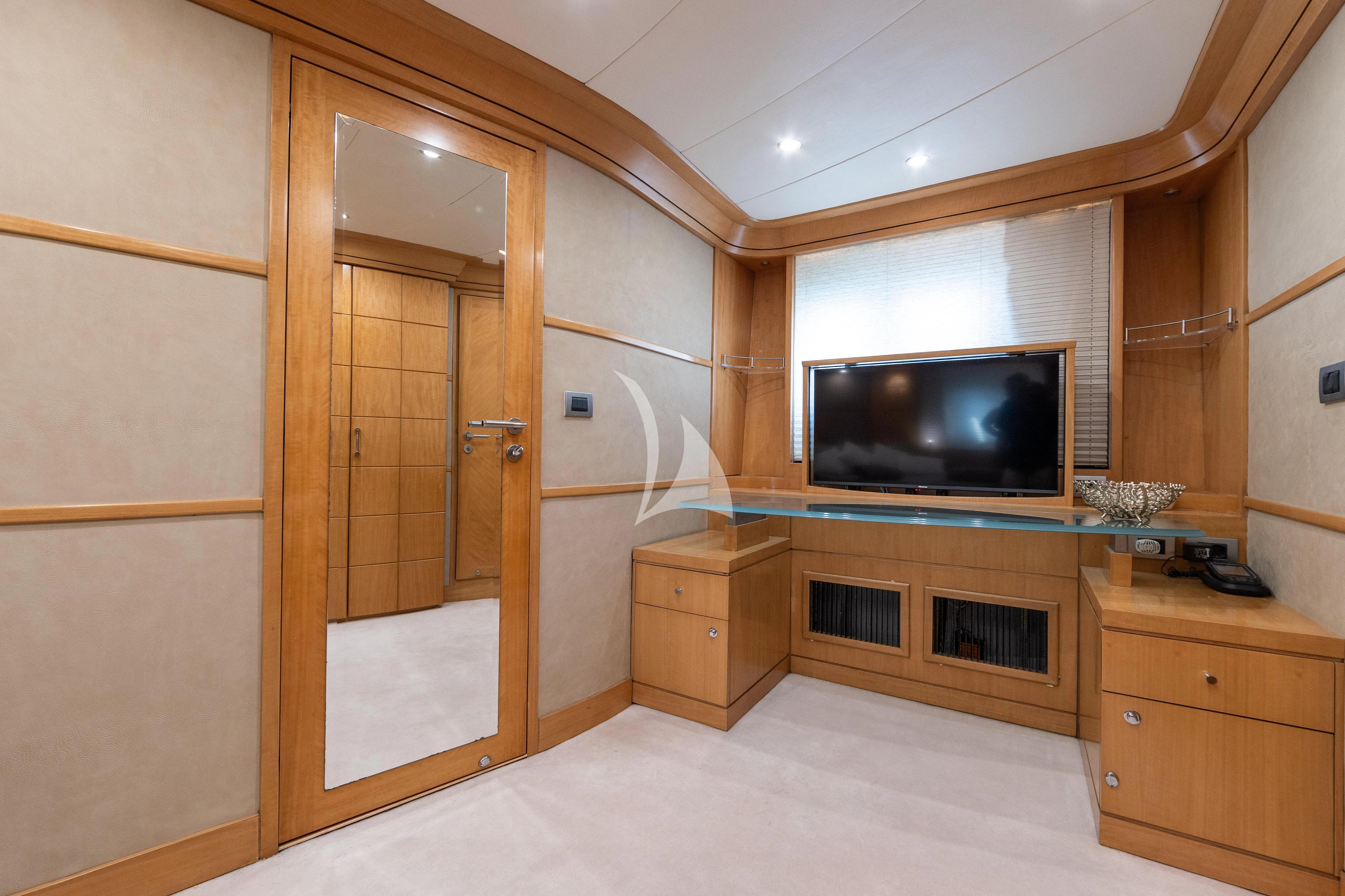 a room with a tv and a cabinet aboard LADY B Yacht for Charter
