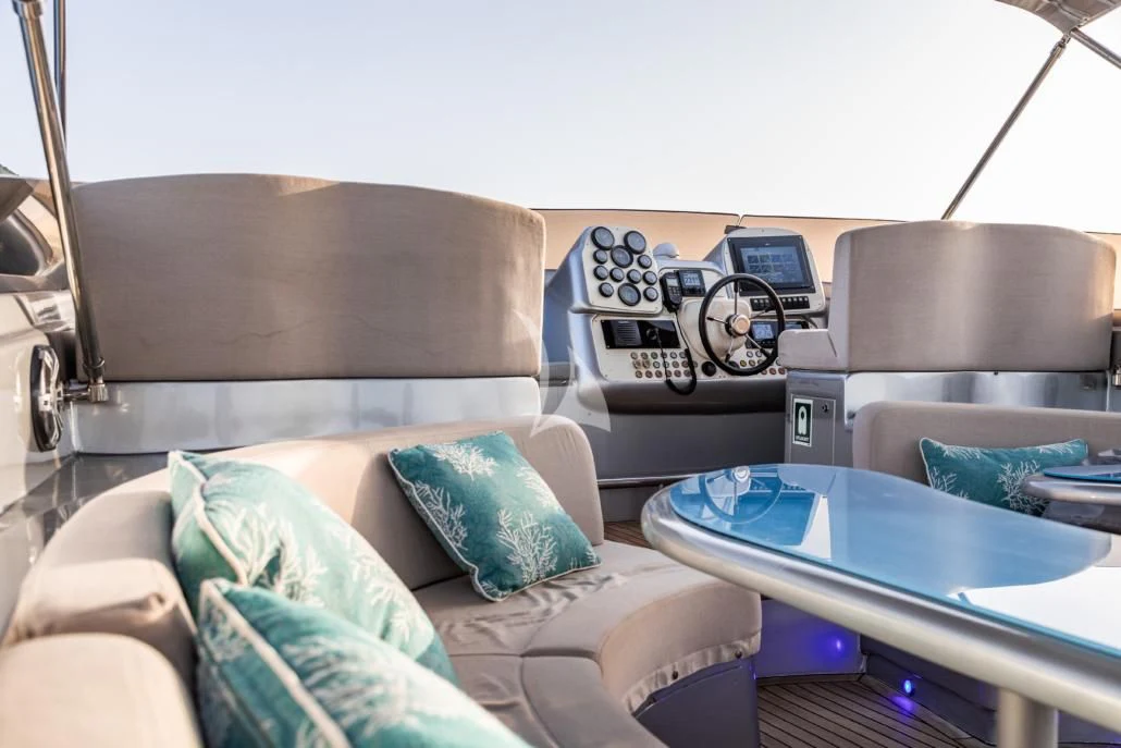 a living room with a leather couch and a laptop on a table aboard LADY B Yacht for Charter