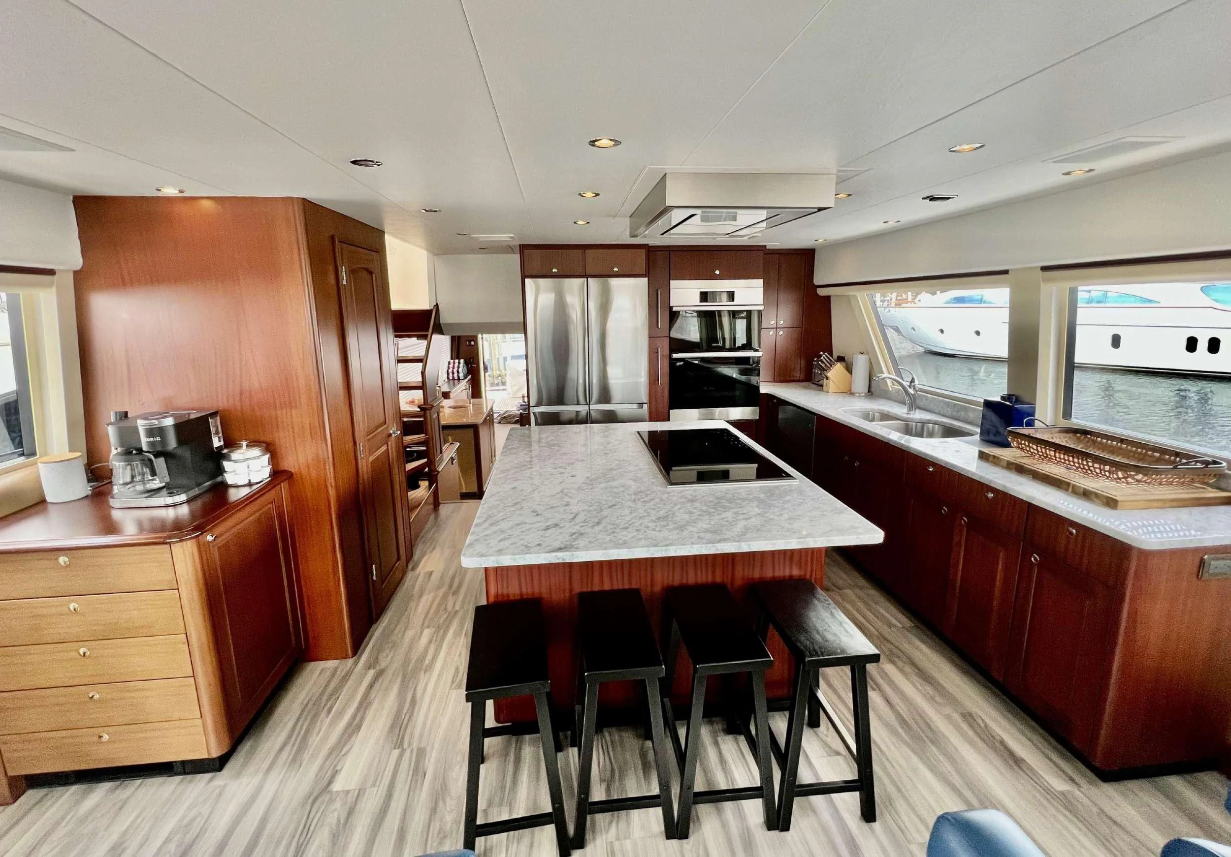 a kitchen with a bar stools and a bar stools aboard LADY B Yacht for Charter