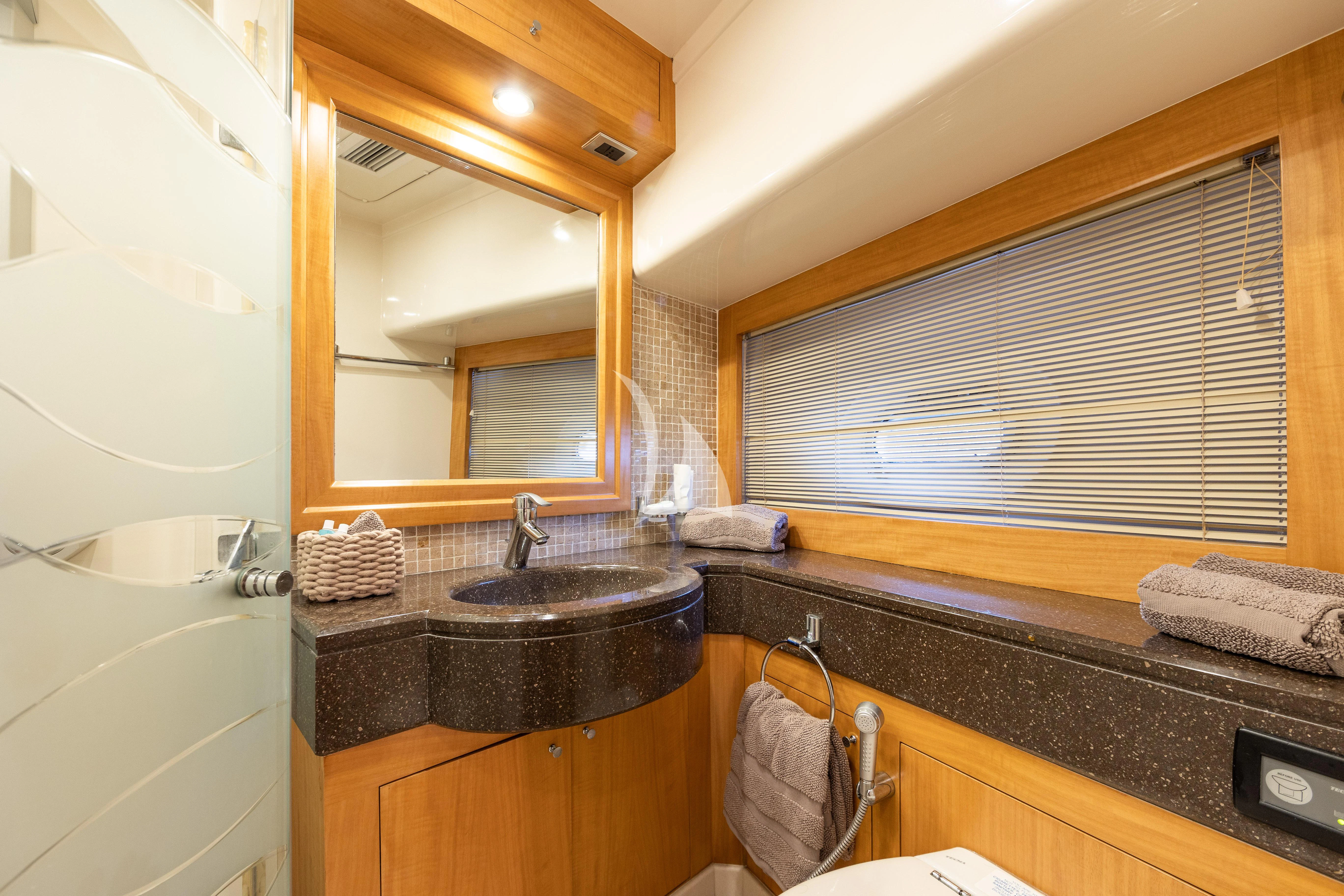 a bathroom with a sink and a mirror aboard LADY B Yacht for Charter