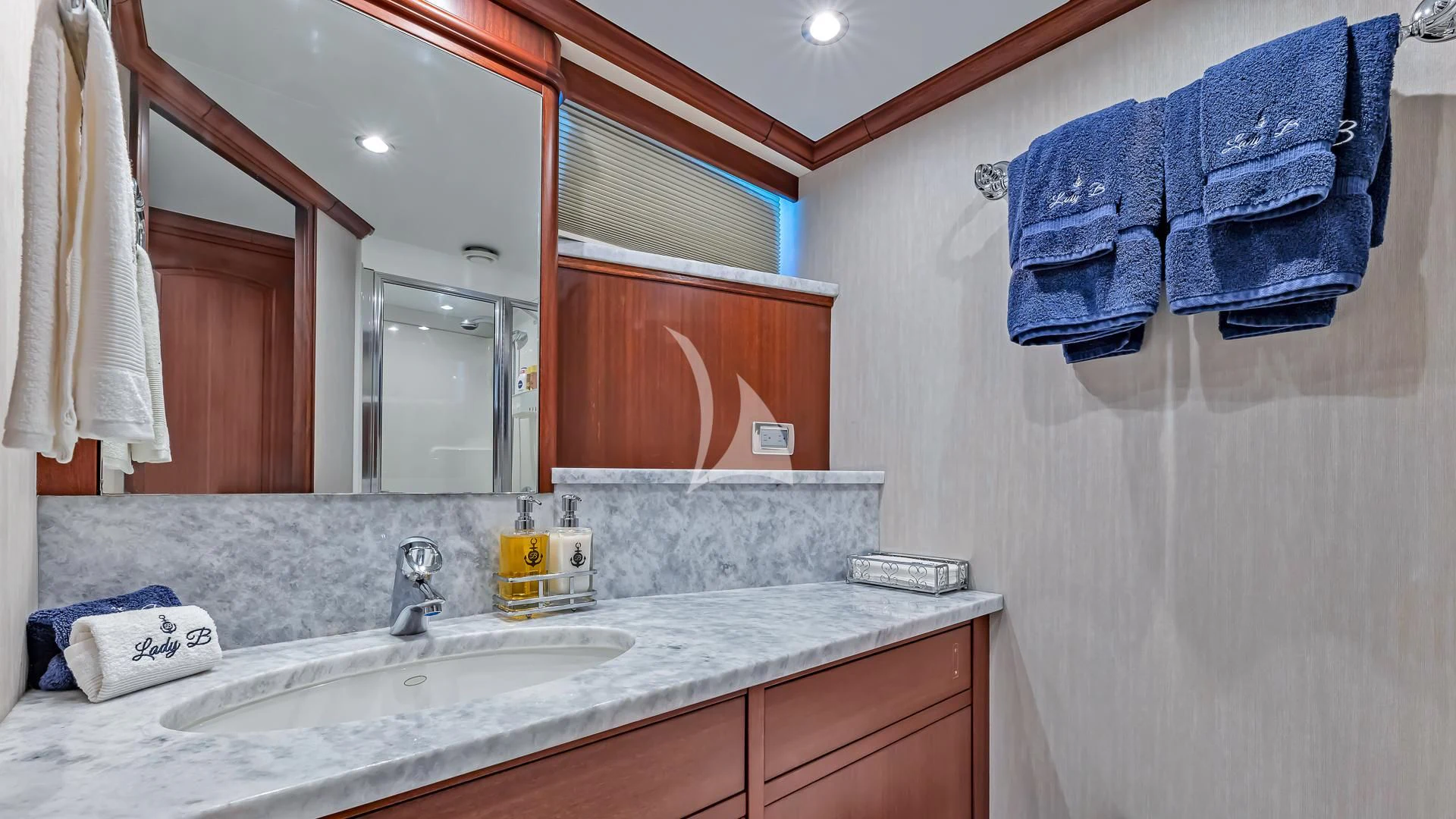 a bathroom with a sink and a mirror aboard LADY B Yacht for Charter