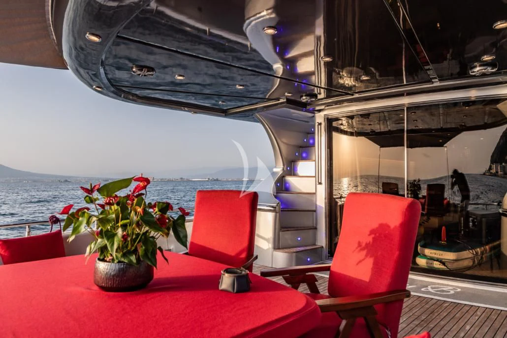 a boat with a red table and chairs on a deck aboard LADY B Yacht for Charter