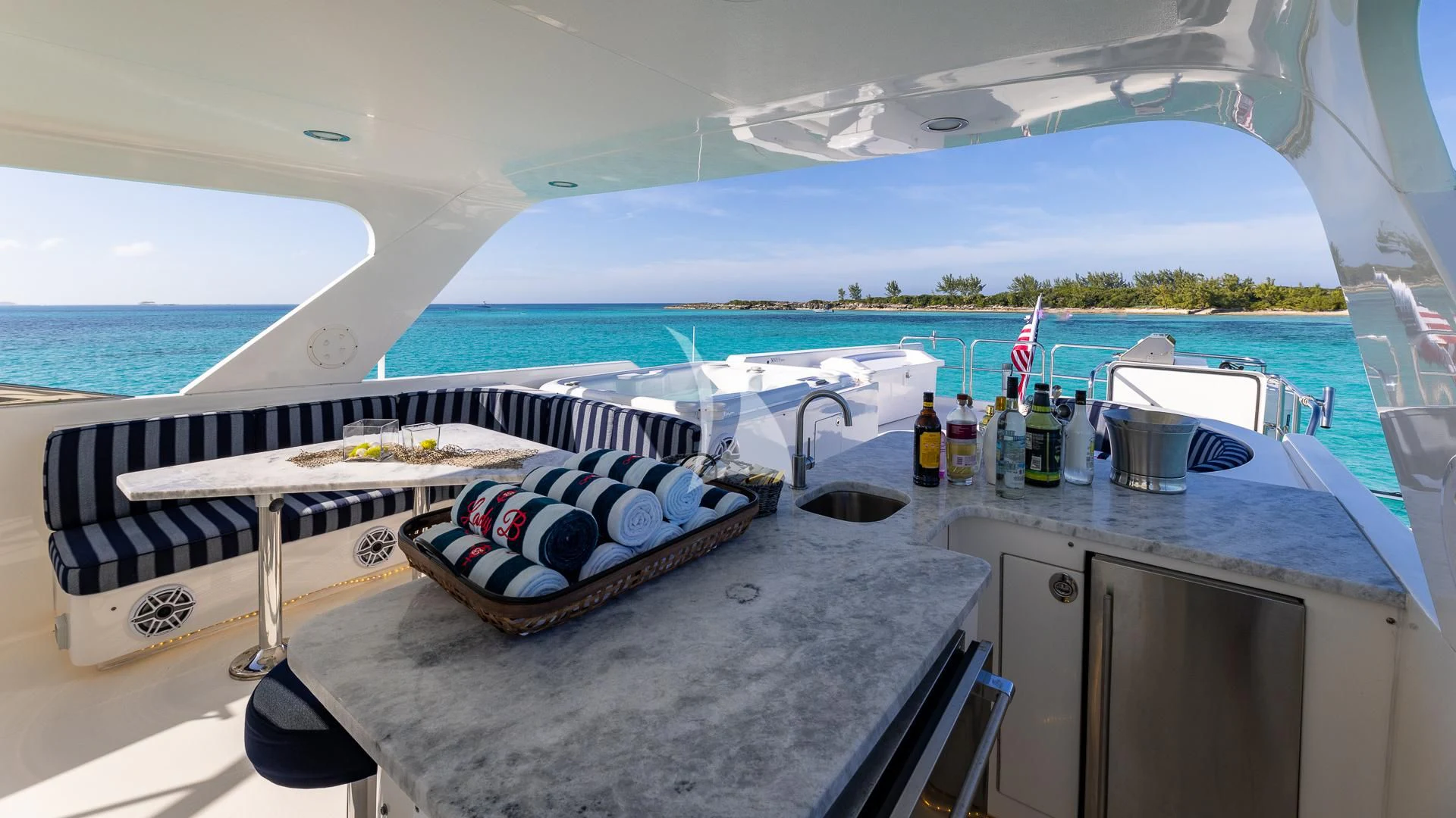 a boat with a picnic table and a view of the ocean aboard LADY B Yacht for Charter