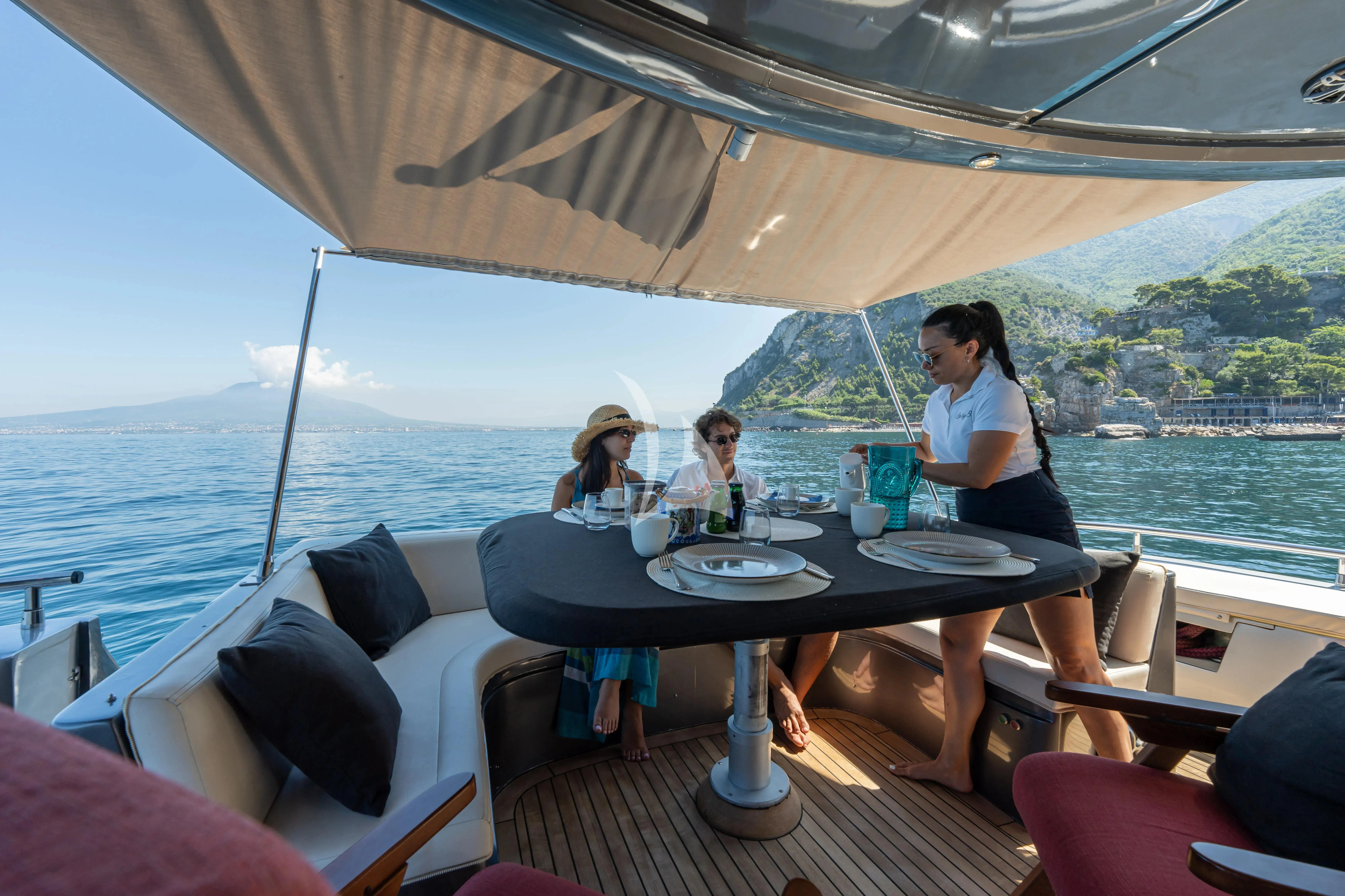 people sitting at a table outside aboard LADY B Yacht for Charter