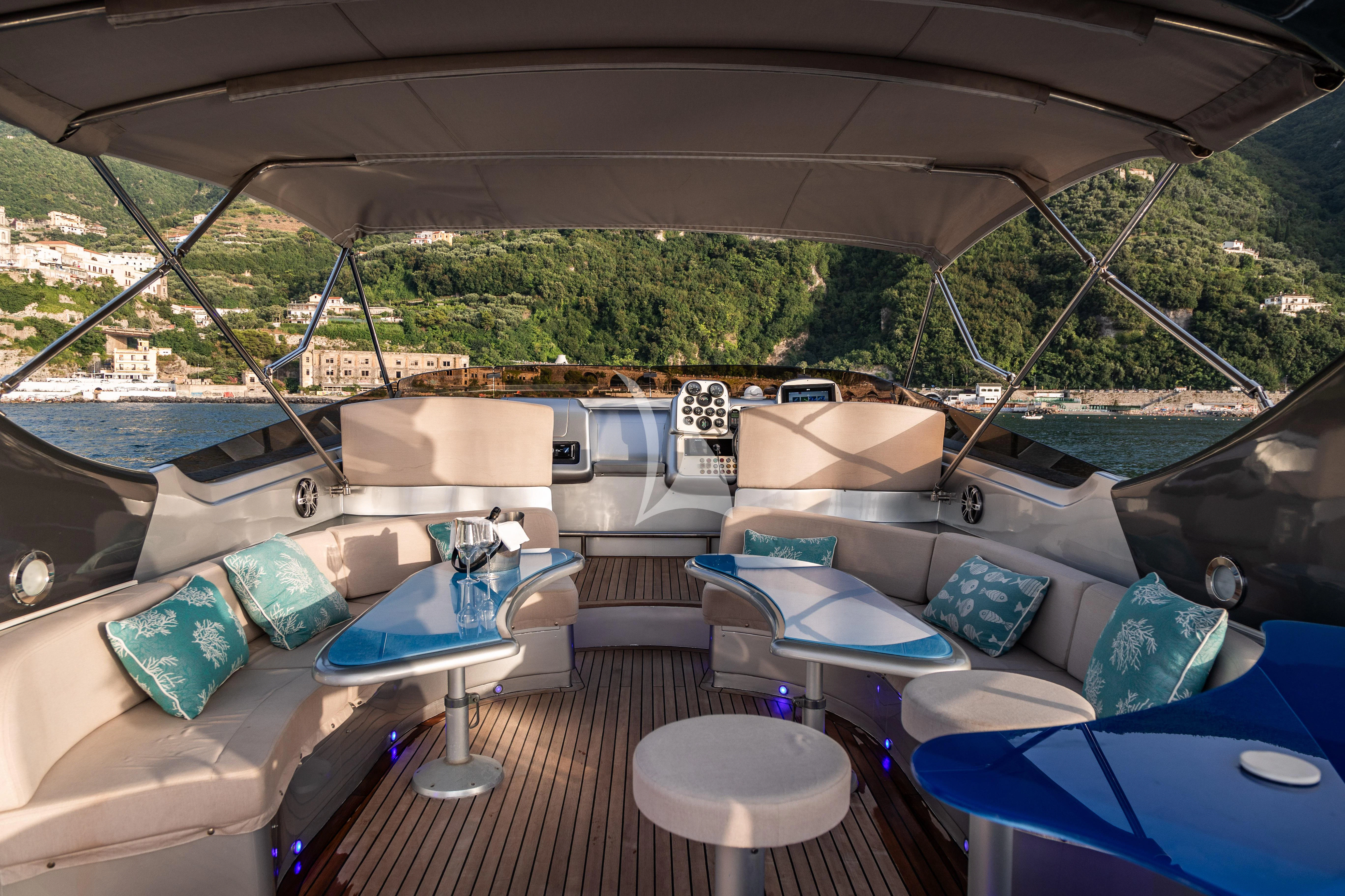inside of a tent with a couch and a table and chairs aboard LADY B Yacht for Charter