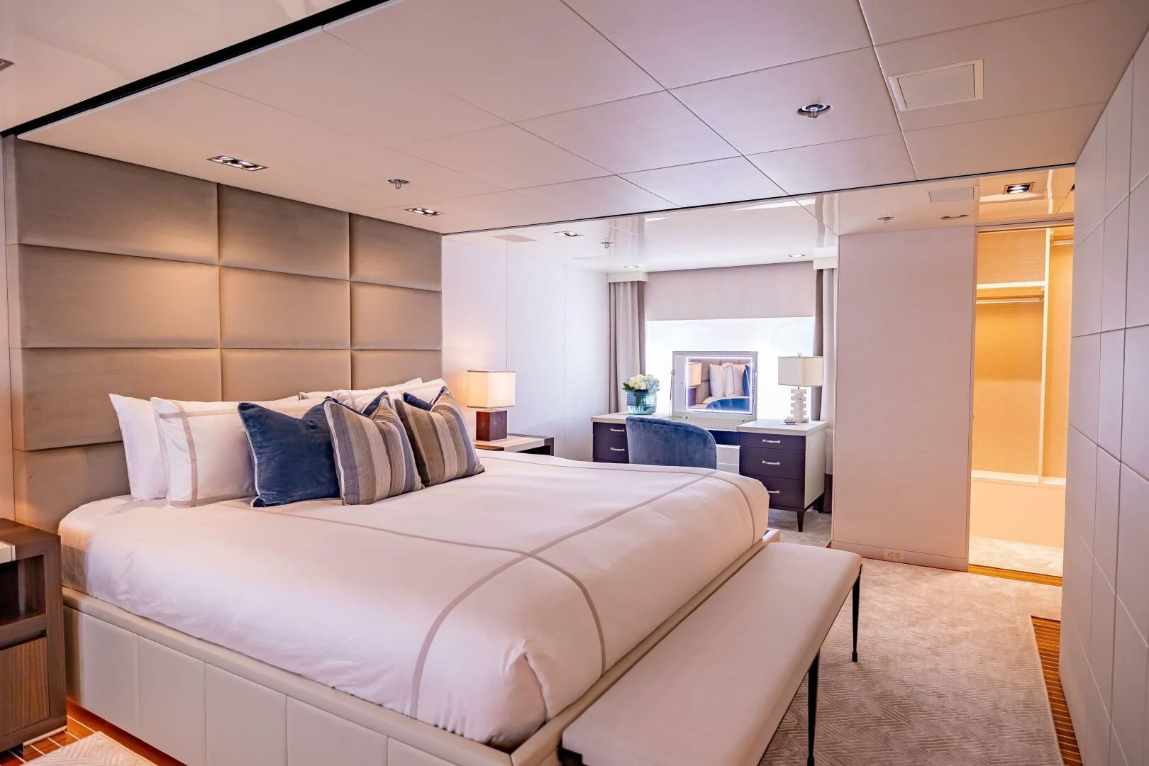 a bedroom with a bed and a desk aboard CHASSEUR Yacht for Charter