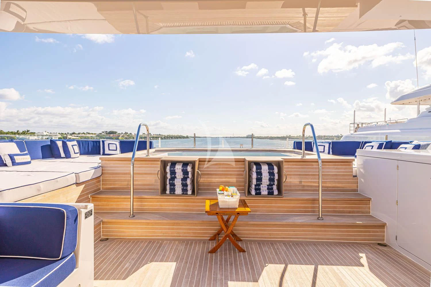 a deck with a table and chairs aboard CHASSEUR Yacht for Charter