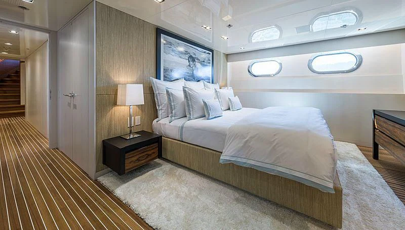 a bedroom with a bed and a lamp aboard CHASSEUR Yacht for Charter