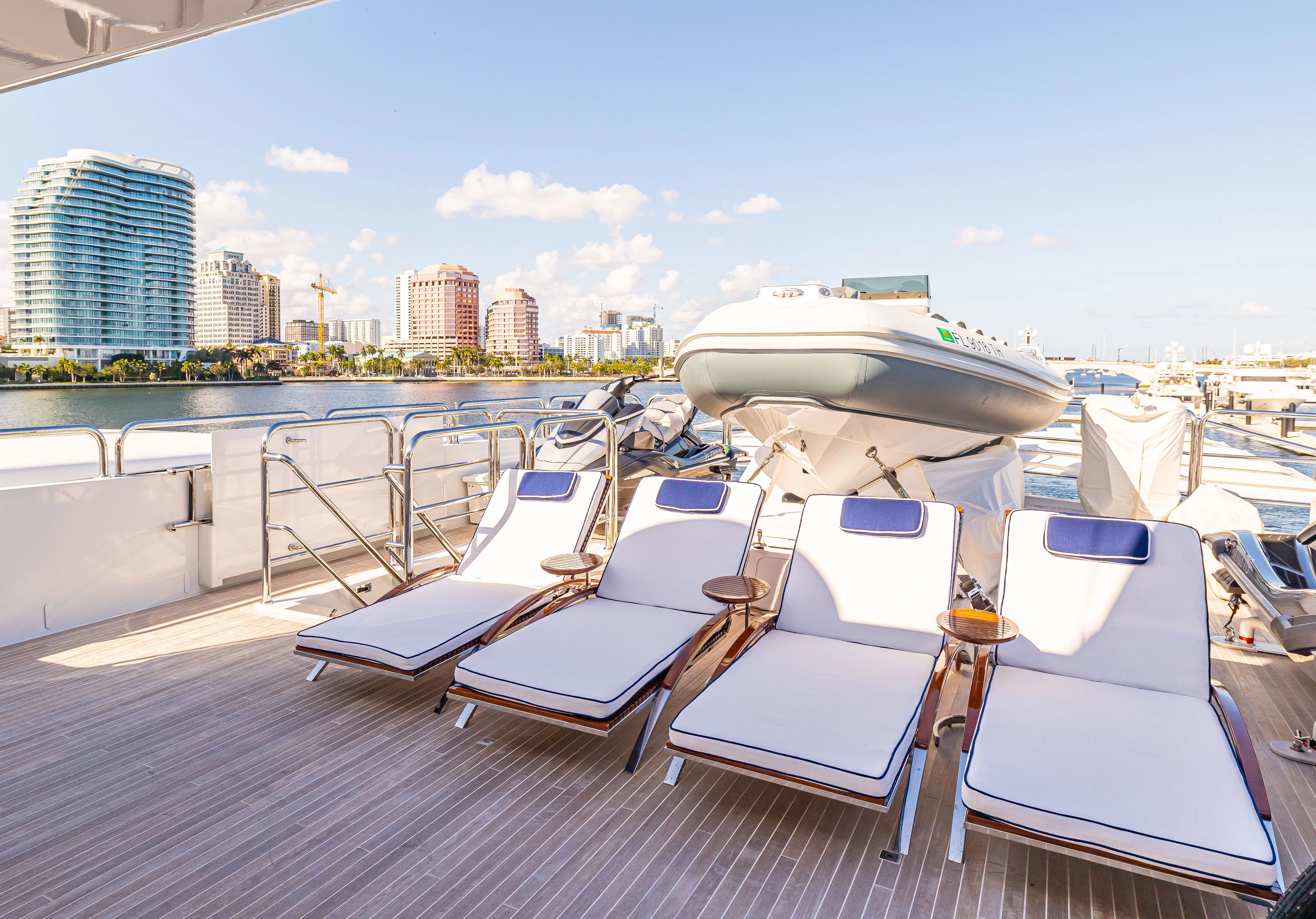 a deck with lounge chairs and boats aboard CHASSEUR Yacht for Charter