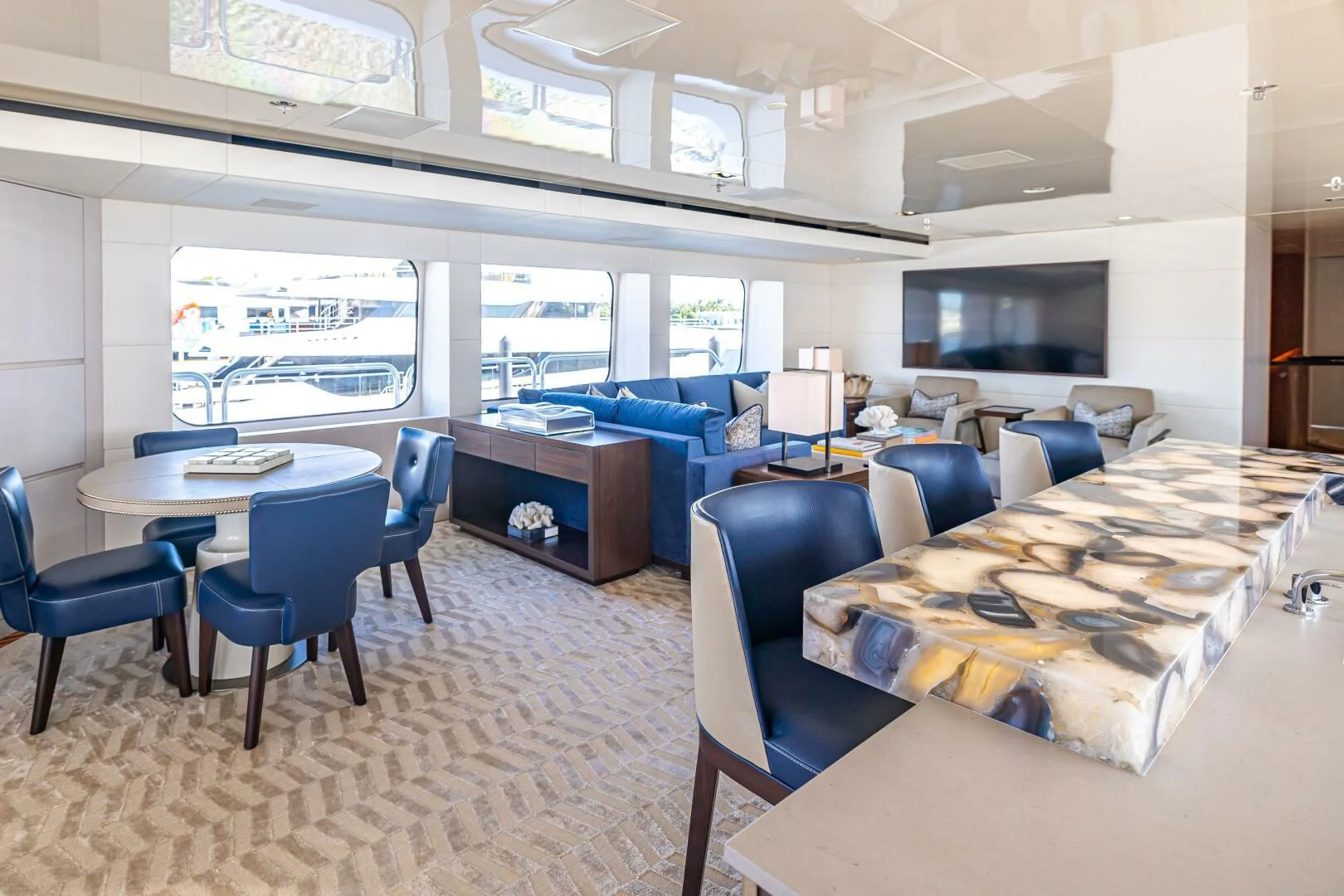 a room with a table chairs and a large window aboard CHASSEUR Yacht for Charter