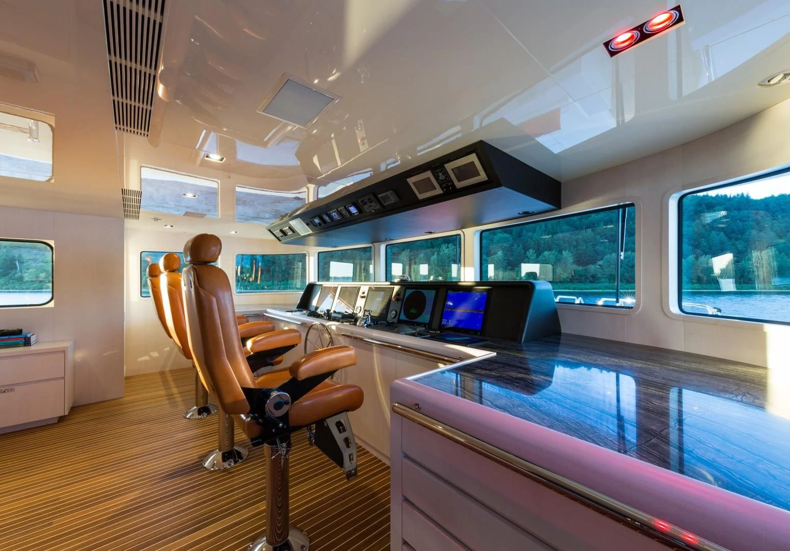 a person sitting in a chair in a room with computers and monitors aboard CHASSEUR Yacht for Charter