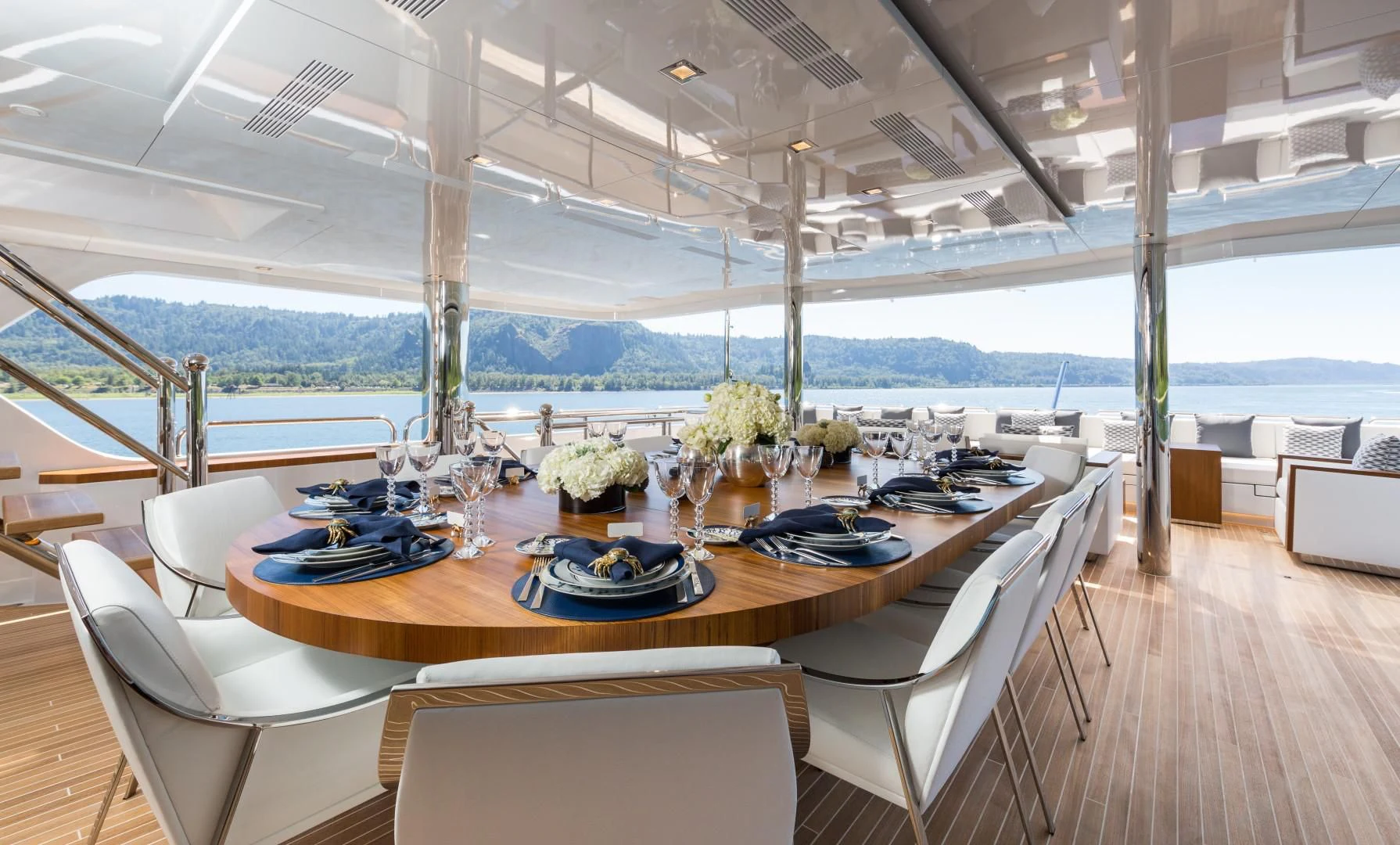 a table with chairs and a plate on it aboard CHASSEUR Yacht for Charter