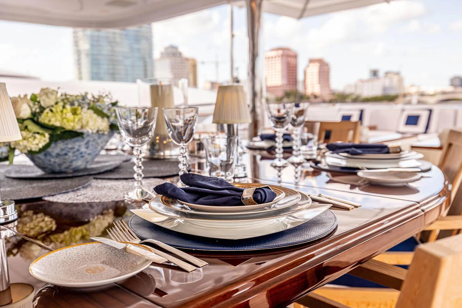 a table with plates and glasses aboard CHASSEUR Yacht for Charter