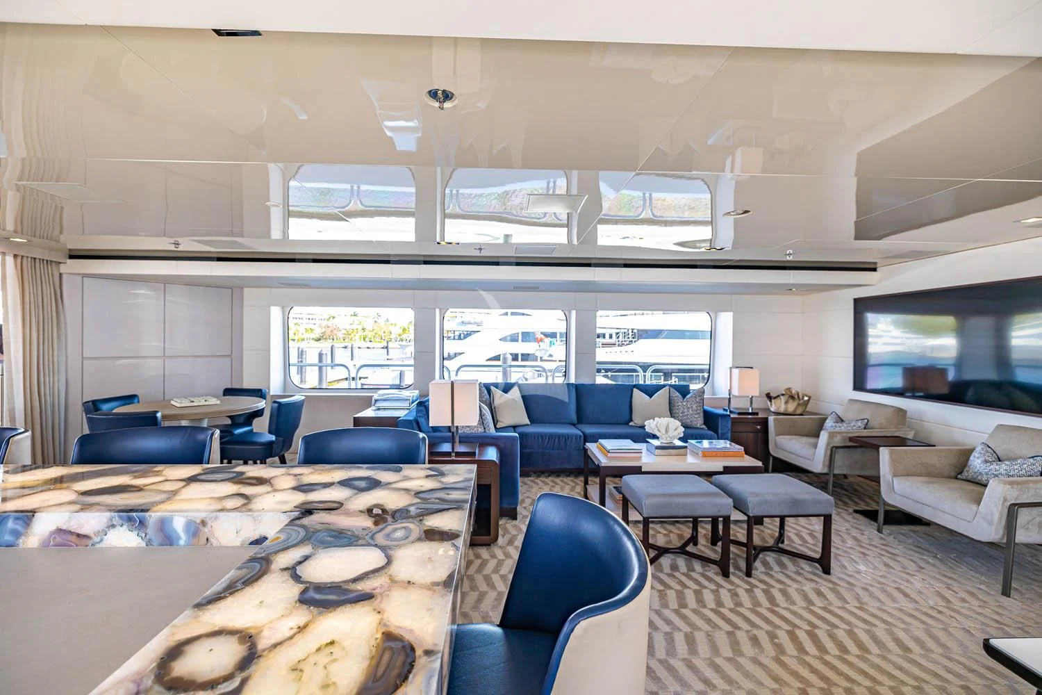 a room with a table chairs and a couch aboard CHASSEUR Yacht for Charter