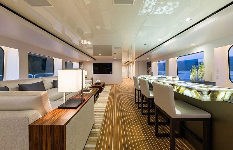 a room with a couch and a table and a tv aboard CHASSEUR Yacht for Charter