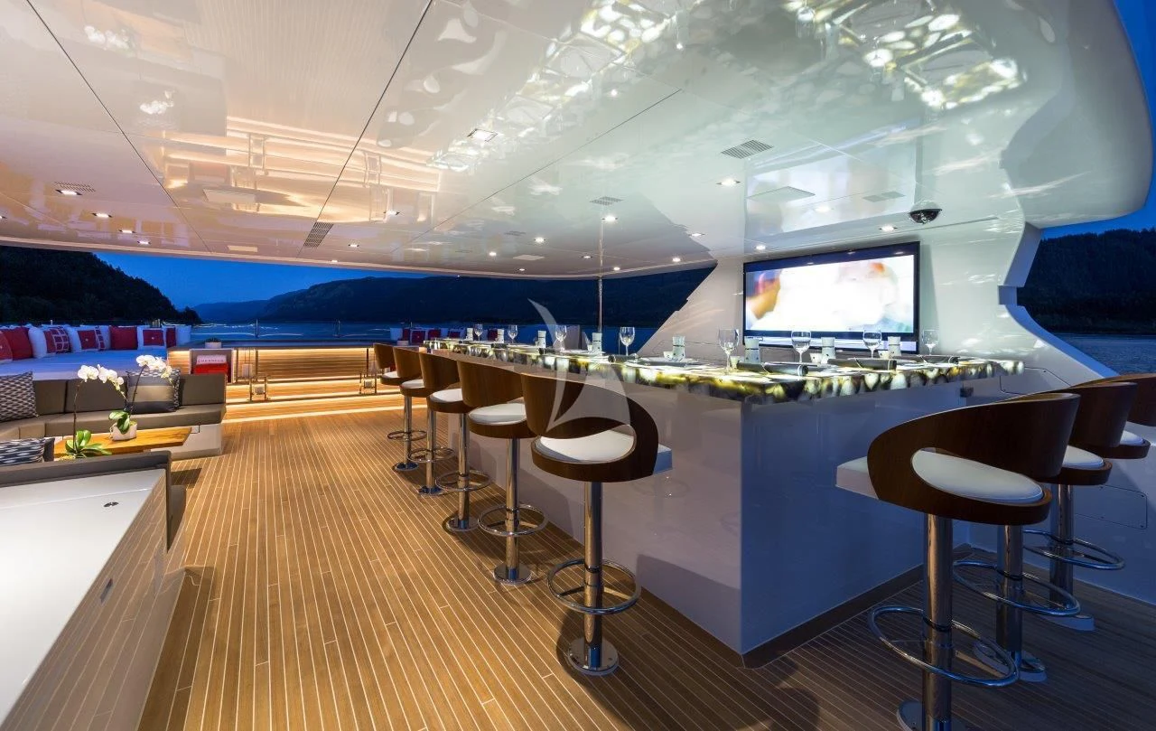 a room with a table and chairs aboard CHASSEUR Yacht for Charter