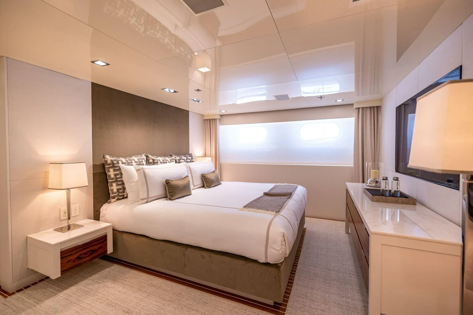 a bedroom with a bed and a tv aboard CHASSEUR Yacht for Charter