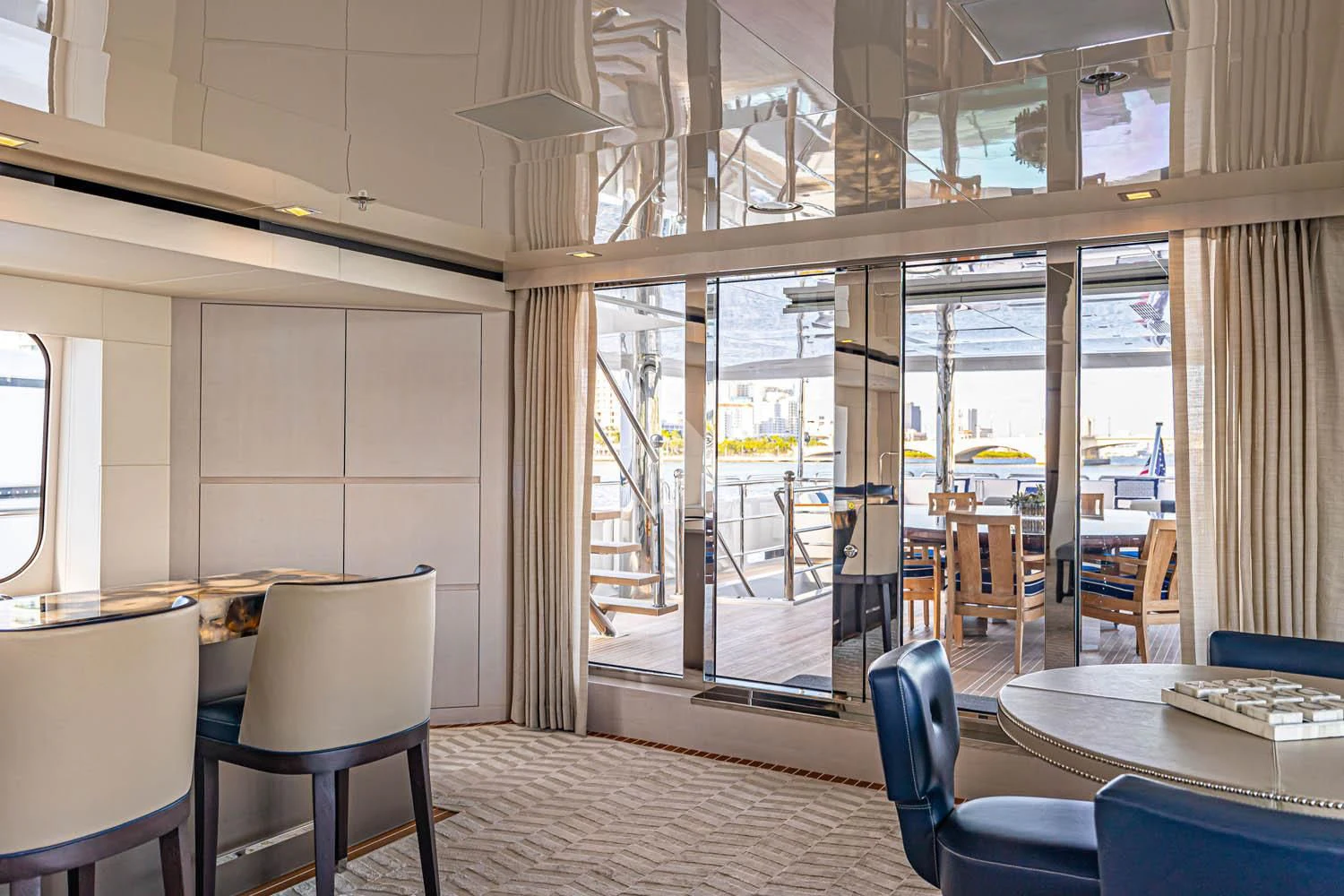 a room with tables and chairs aboard CHASSEUR Yacht for Charter