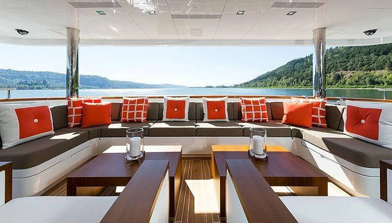 a room with couches and tables aboard CHASSEUR Yacht for Charter