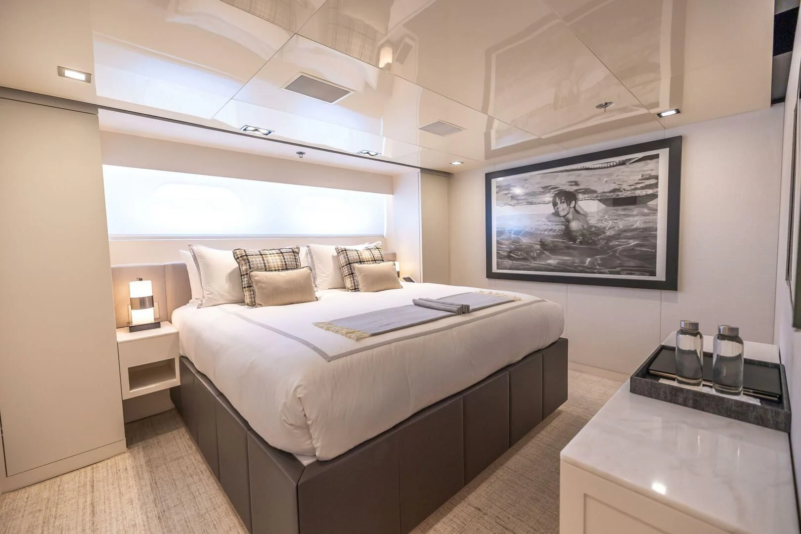 a bedroom with a bed and a tv on the wall aboard CHASSEUR Yacht for Charter