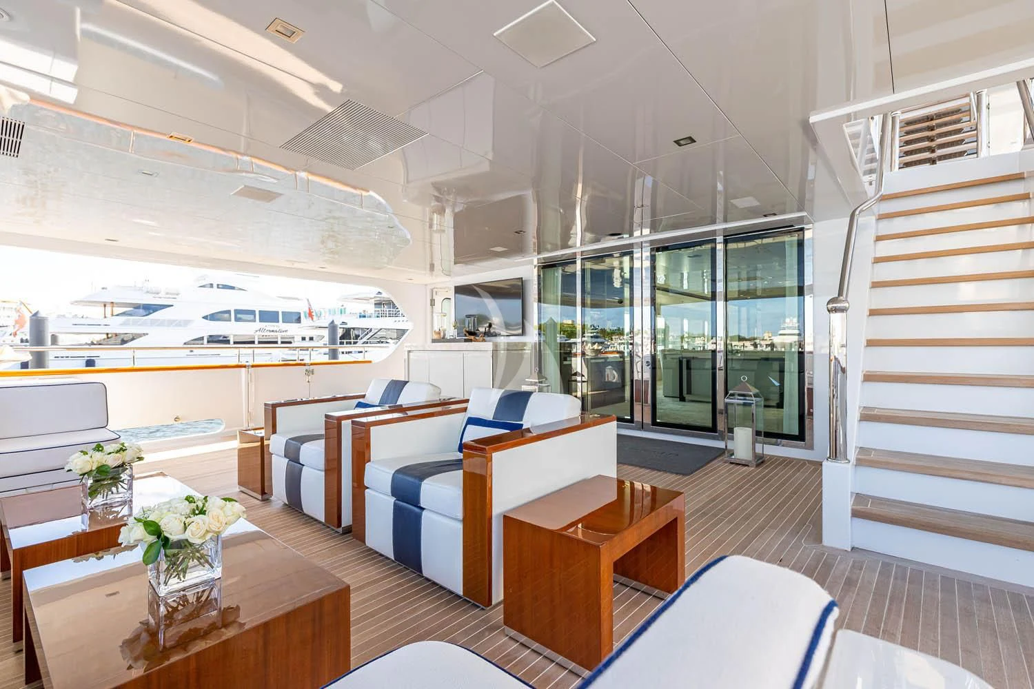 a room with a table chairs and a staircase aboard CHASSEUR Yacht for Charter