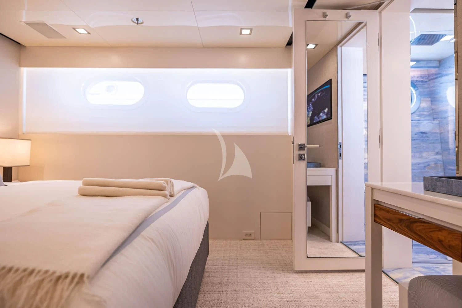 a room with a bed and a desk aboard CHASSEUR Yacht for Charter