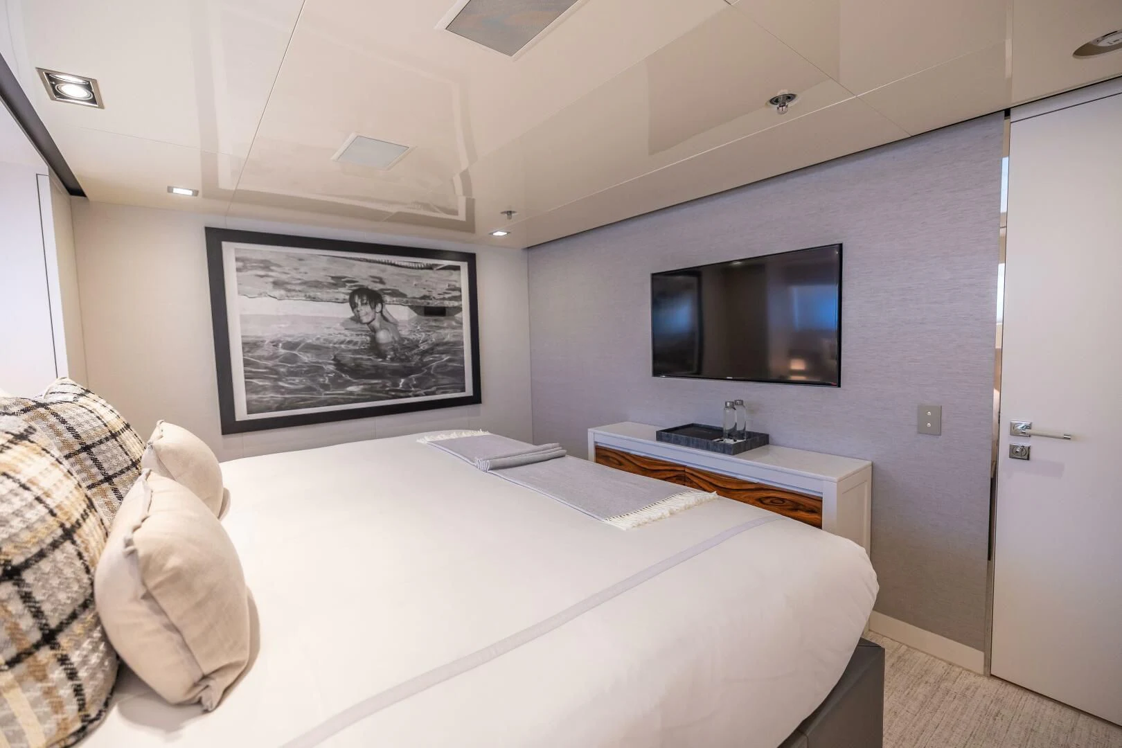 a bedroom with a bed and tv aboard CHASSEUR Yacht for Charter