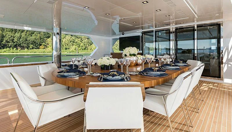 a dining room with a table and chairs aboard CHASSEUR Yacht for Charter
