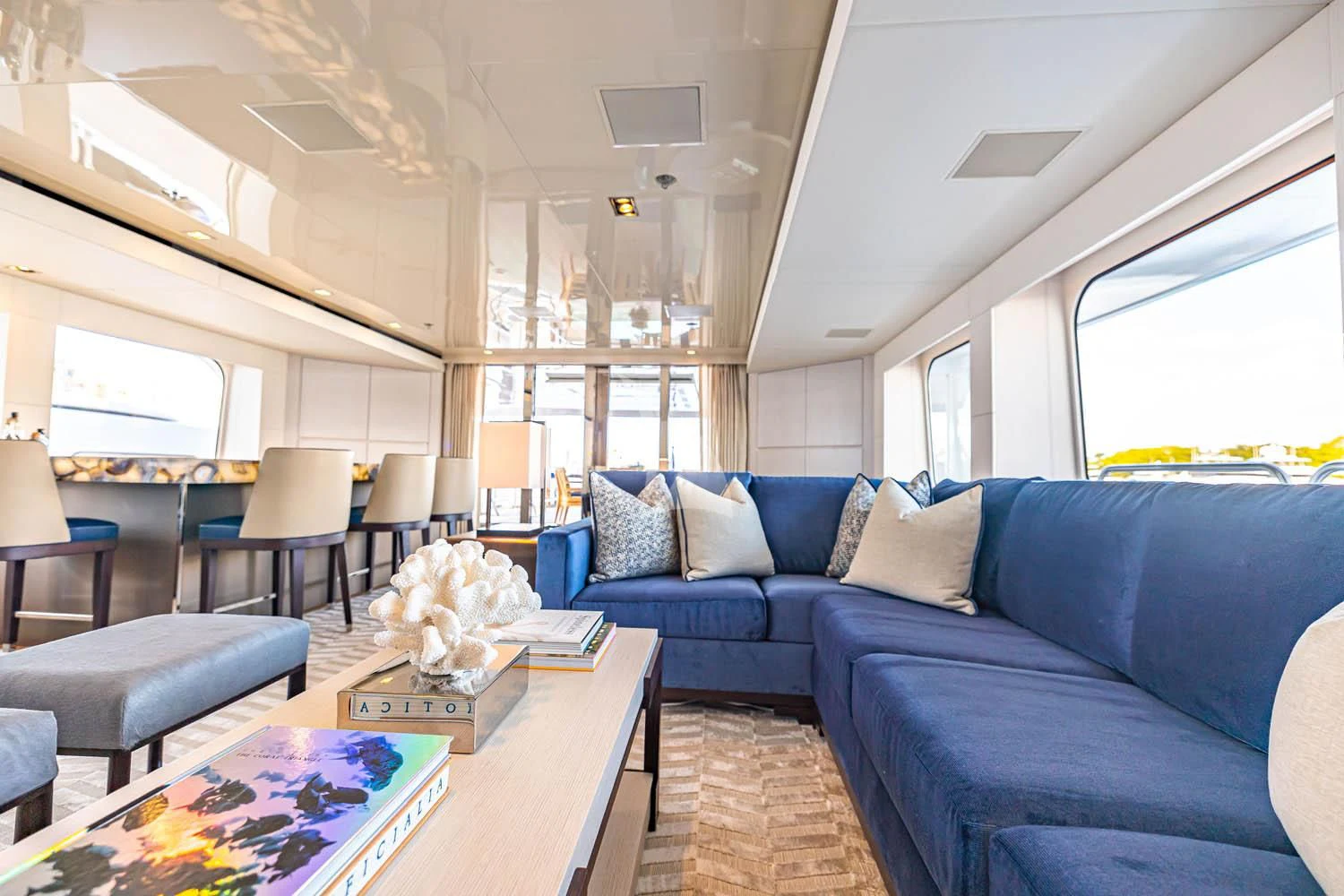 a living room with a blue couch aboard CHASSEUR Yacht for Charter