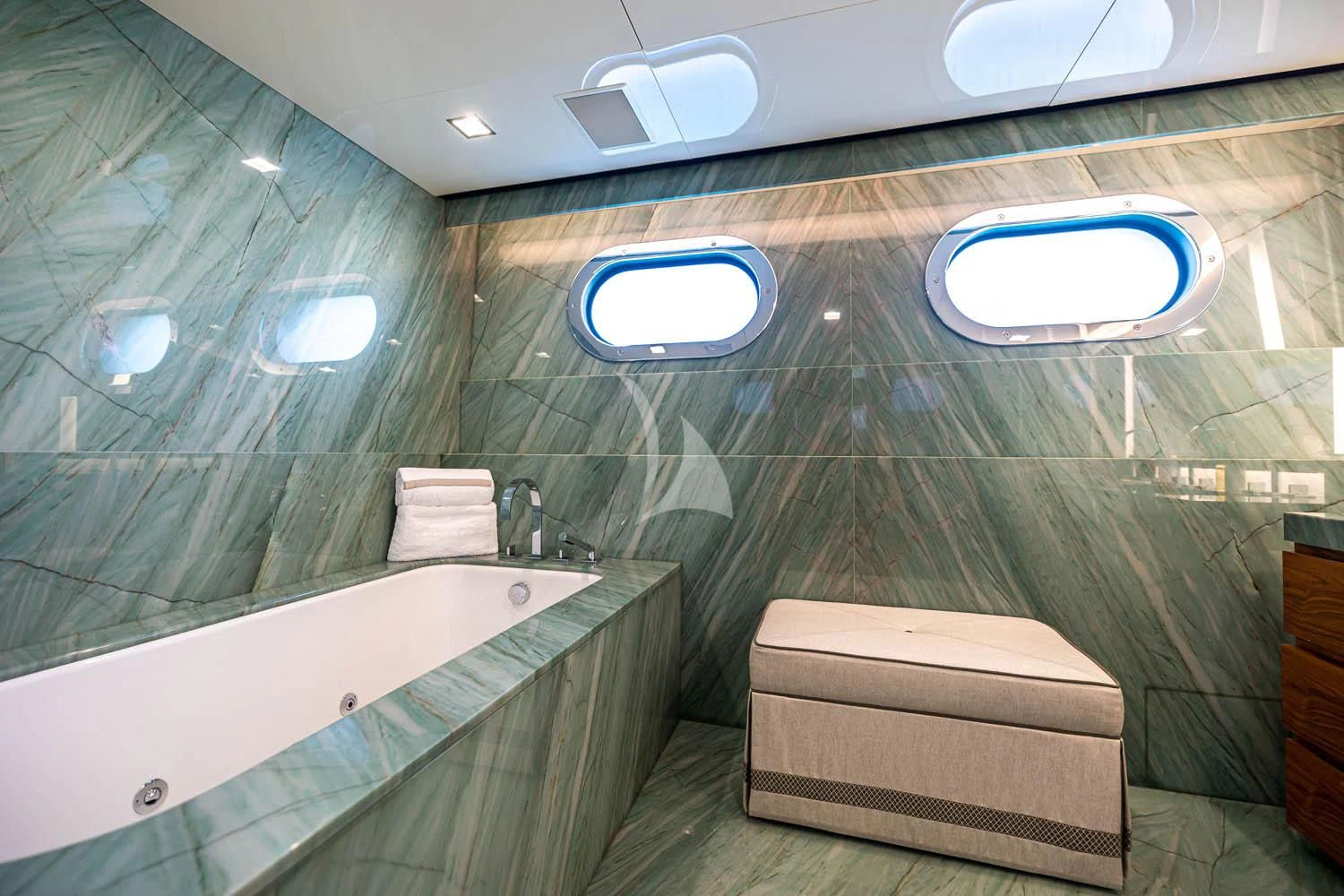 a bathroom with a tub and sinks aboard CHASSEUR Yacht for Charter