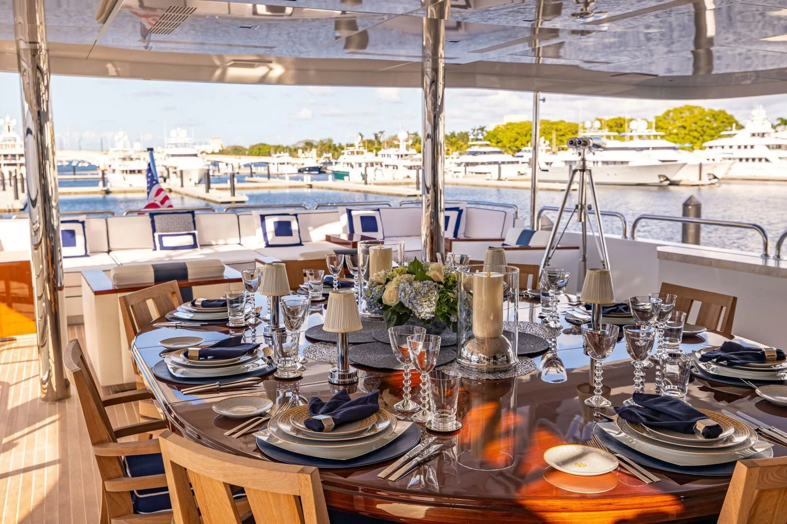 a table set with plates and glasses aboard CHASSEUR Yacht for Charter