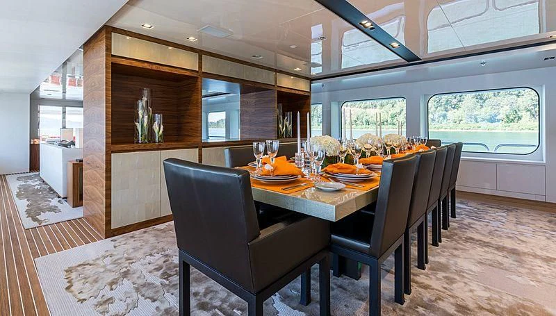 a dining table in a room aboard CHASSEUR Yacht for Charter