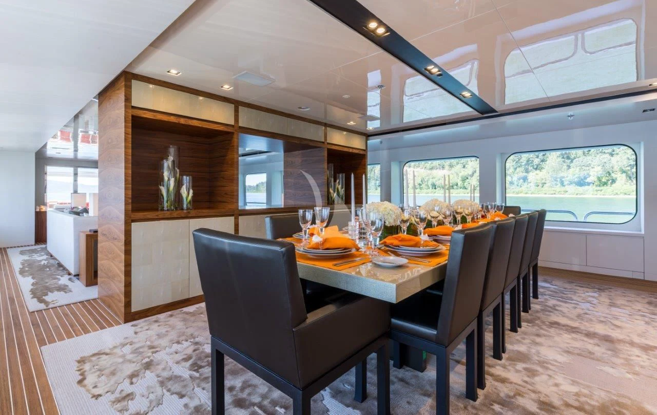 a dining table in a room aboard CHASSEUR Yacht for Charter