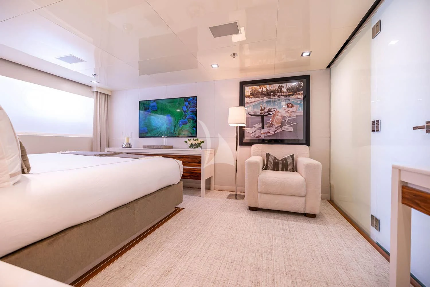 a bedroom with a large screen aboard CHASSEUR Yacht for Charter