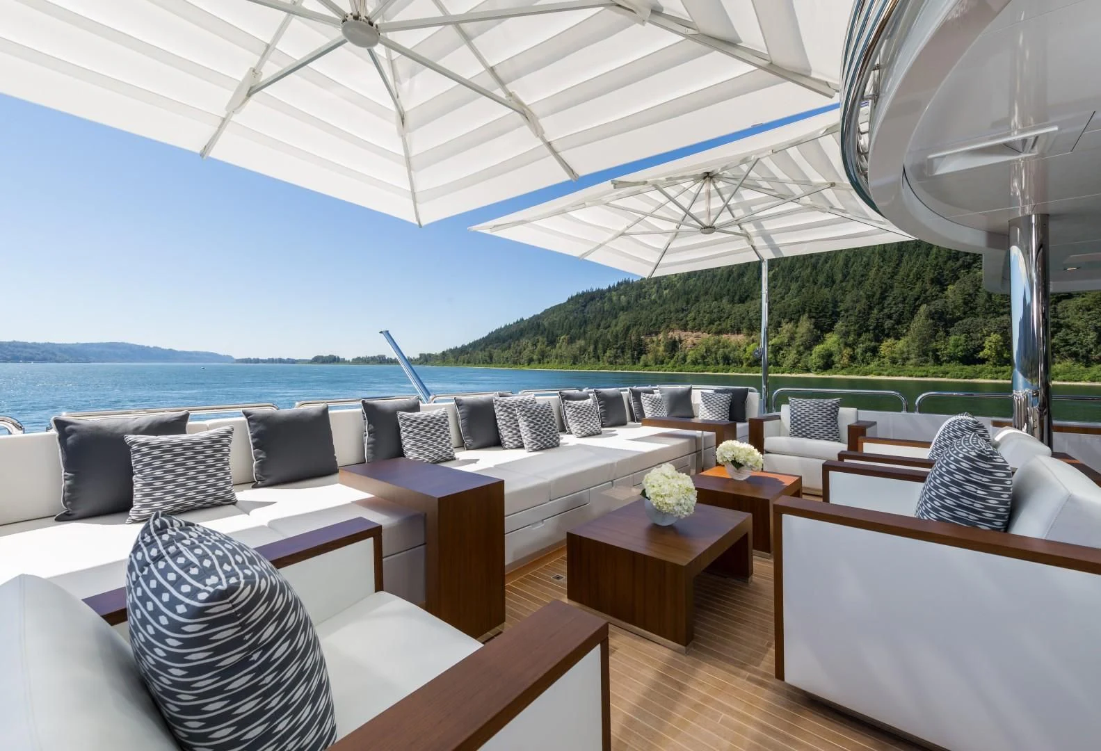 a large white tent with a couch and a table and chairs aboard CHASSEUR Yacht for Charter
