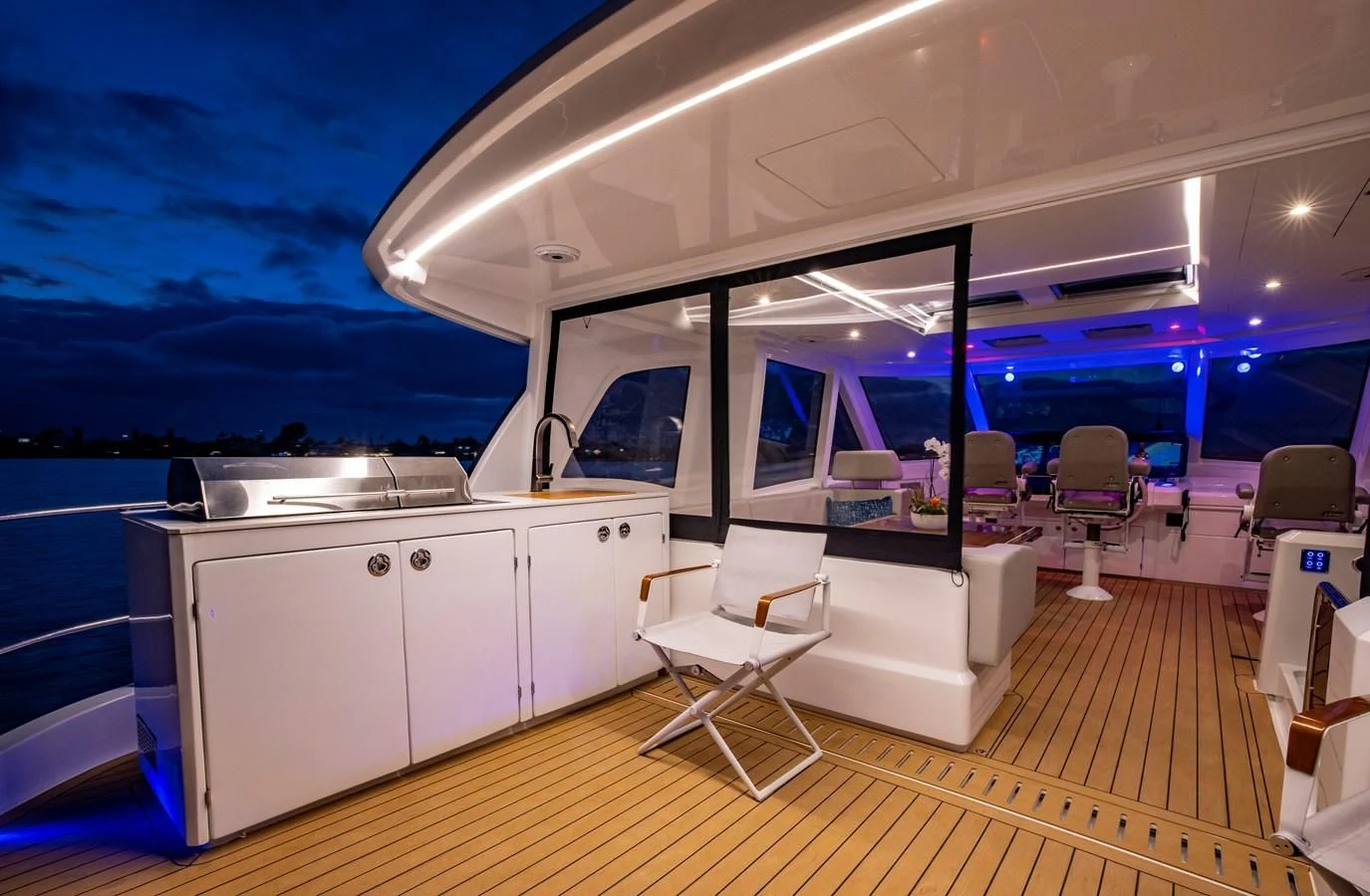 a room with a deck and a view of the ocean aboard PLANE TO SEA Yacht for Sale