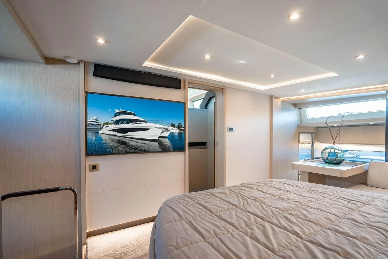 a bedroom with a bed and a television aboard PLANE TO SEA Yacht for Sale