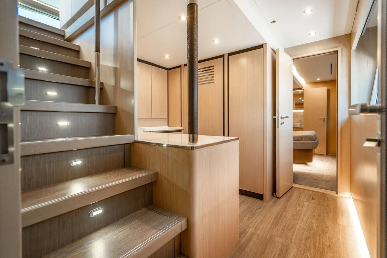a bathroom with wood floors aboard PLANE TO SEA Yacht for Sale