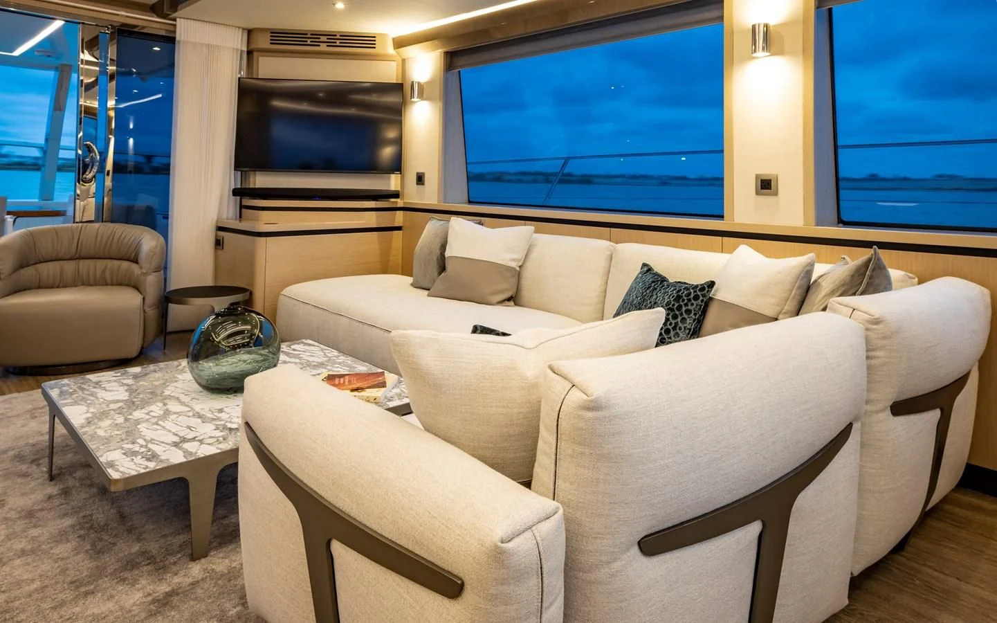 a living room with a large window aboard PLANE TO SEA Yacht for Sale