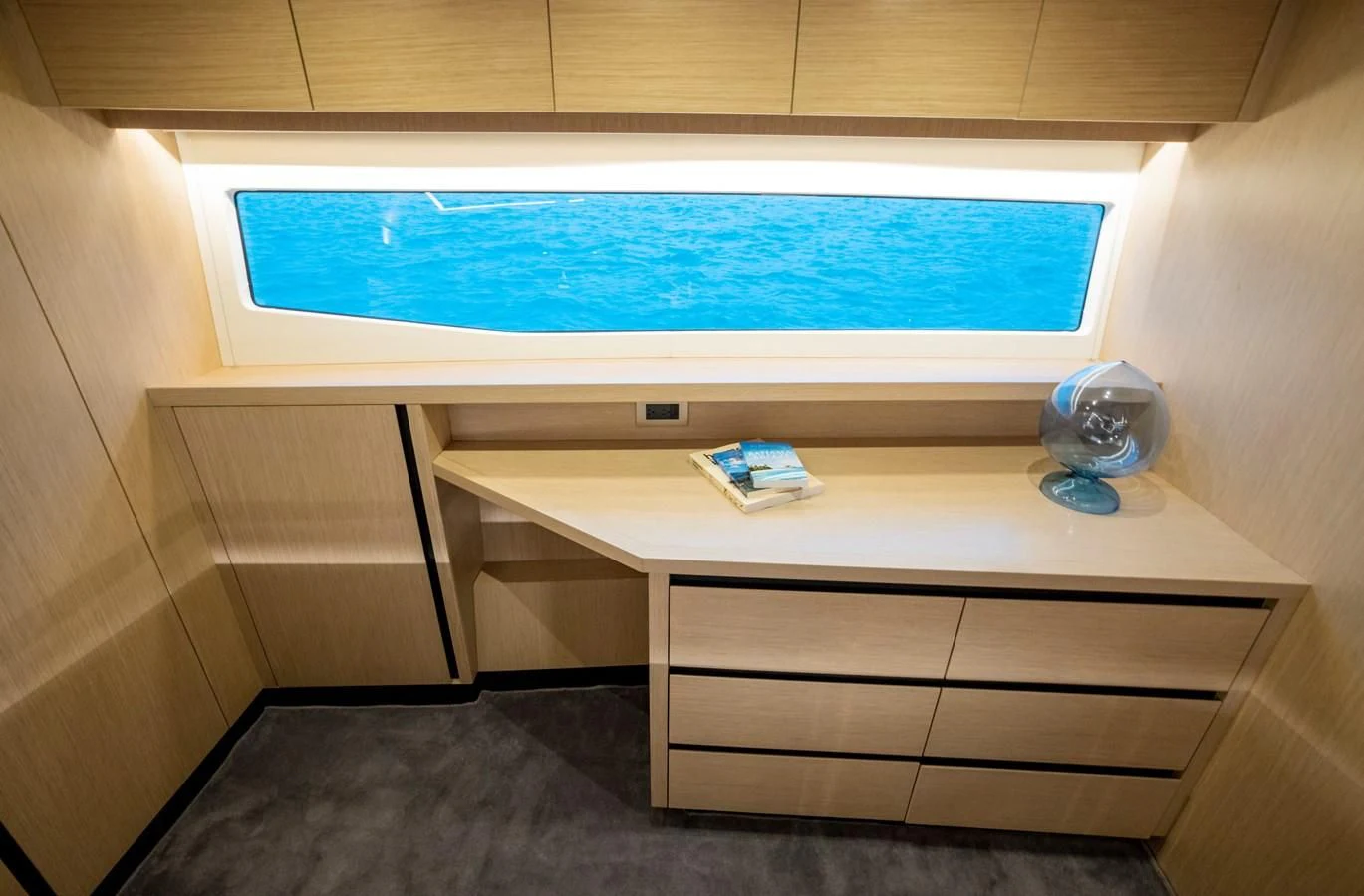 a computer on a desk aboard PLANE TO SEA Yacht for Sale