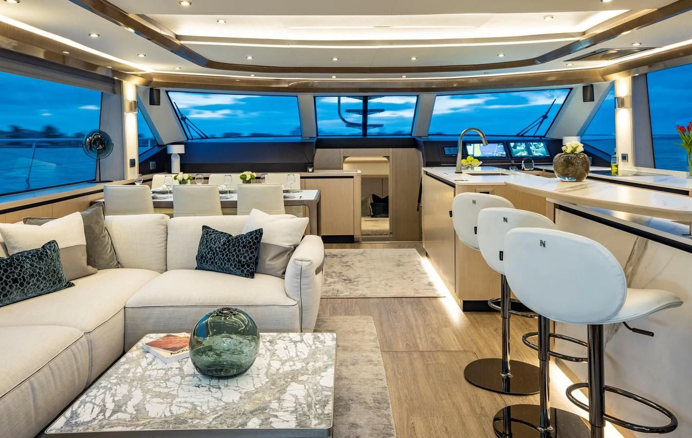 a living room with a large window aboard PLANE TO SEA Yacht for Sale