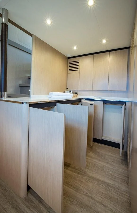 a kitchen with white cabinets aboard PLANE TO SEA Yacht for Sale