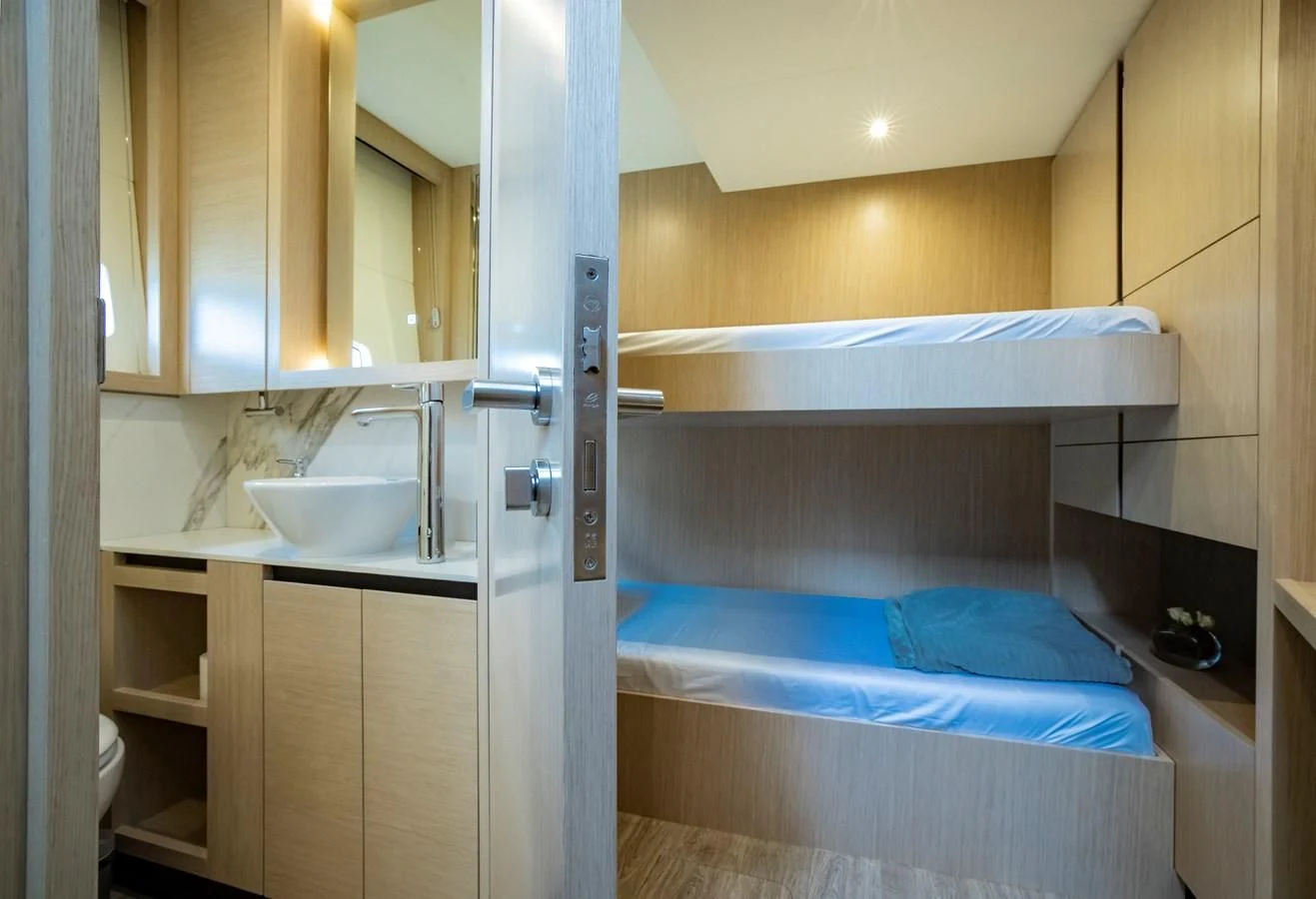 a bathroom with a sink and a bed aboard PLANE TO SEA Yacht for Sale