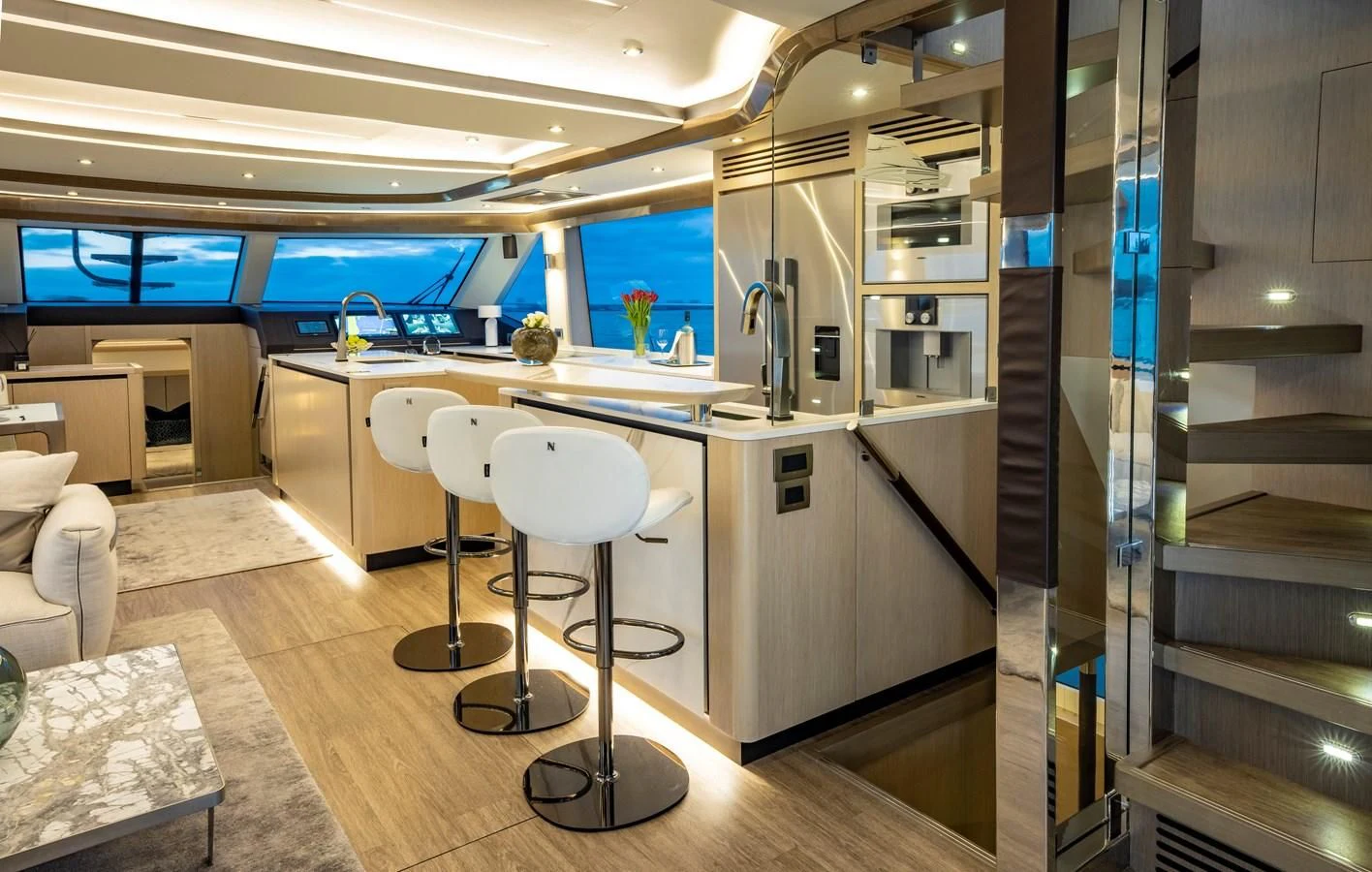 a kitchen with a large glass wall aboard PLANE TO SEA Yacht for Sale