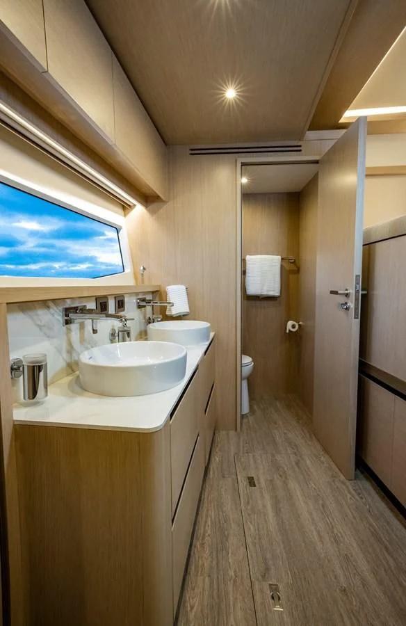 a bathroom with a sink and a mirror aboard PLANE TO SEA Yacht for Sale